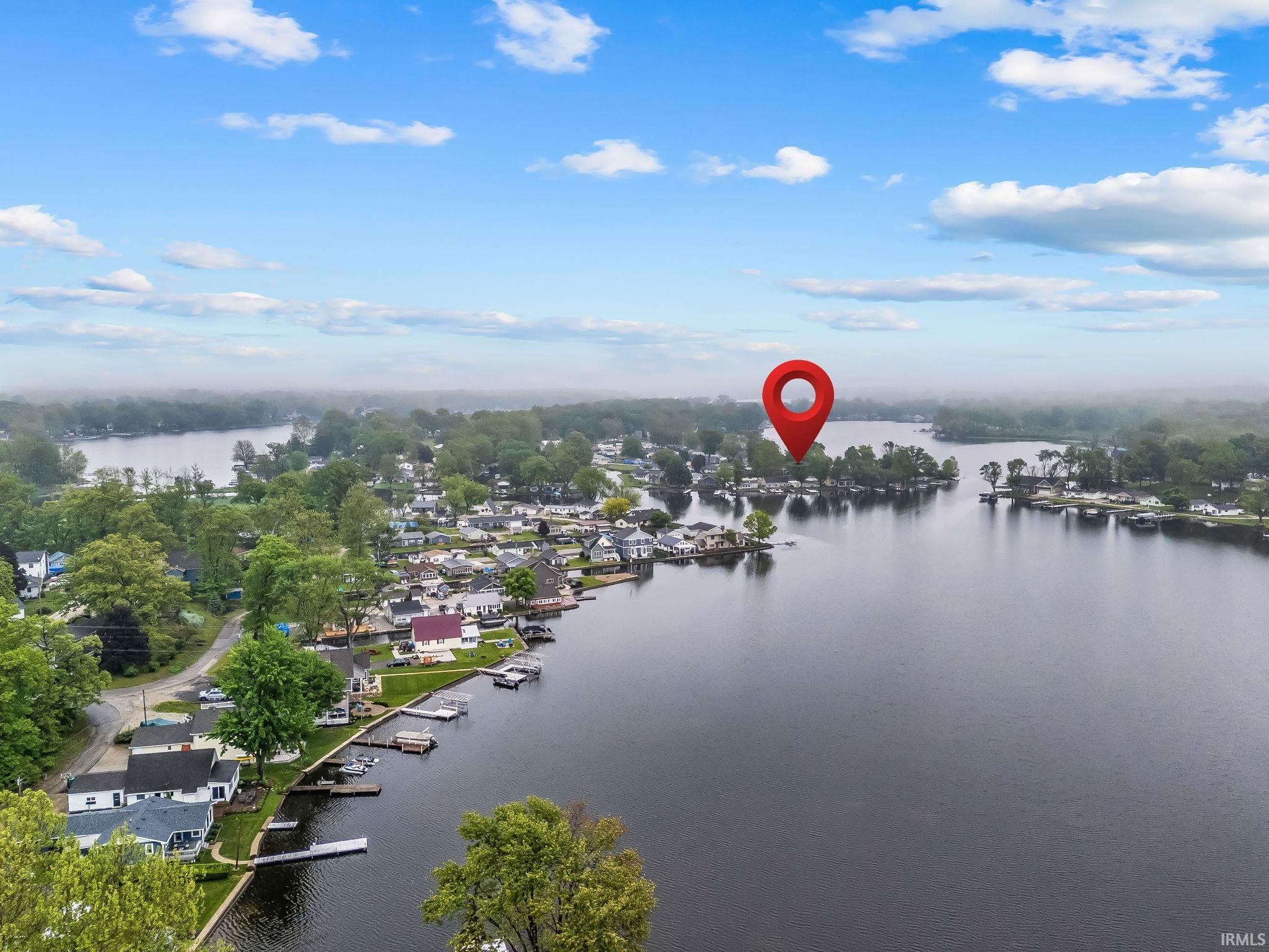 Aerial perspective showcasing a waterfront community with numerous properties bordering the water
