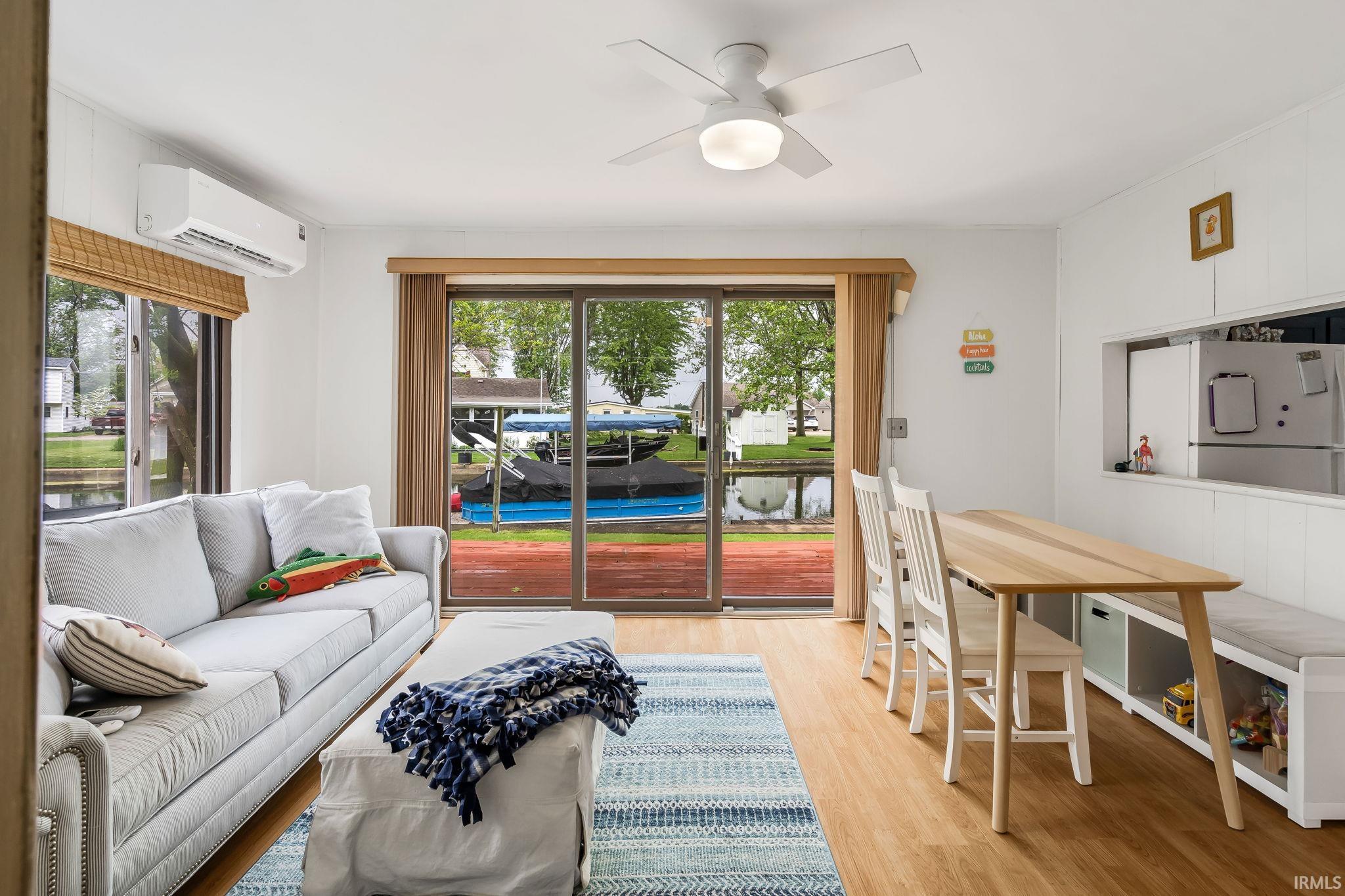 Open-concept living area featuring wood-finish flooring and a ceiling fan