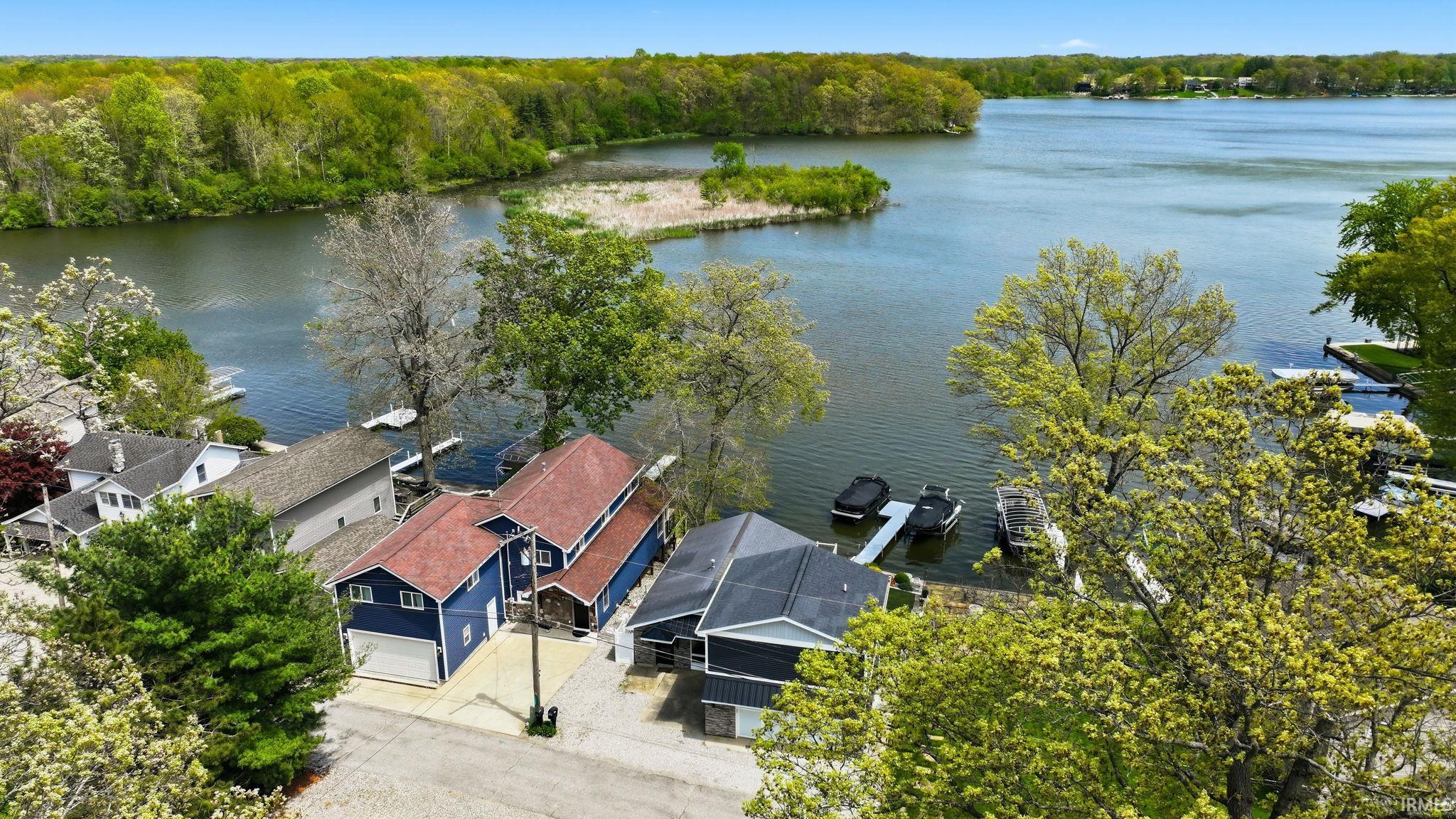 Waterfront property with private docks and lush green surroundings