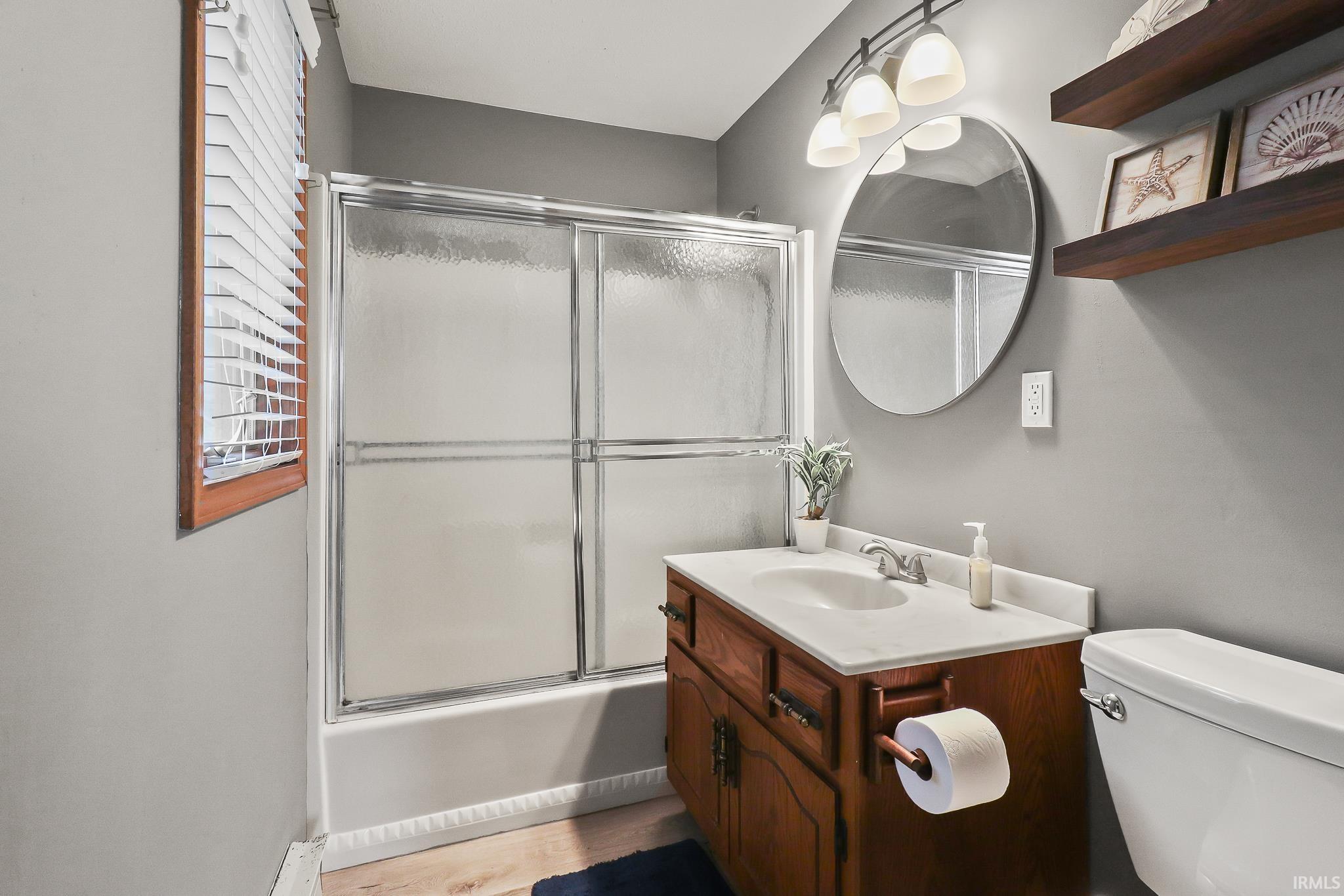 Bathroom with a built-in wood vanity, integrated sink, and white countertop