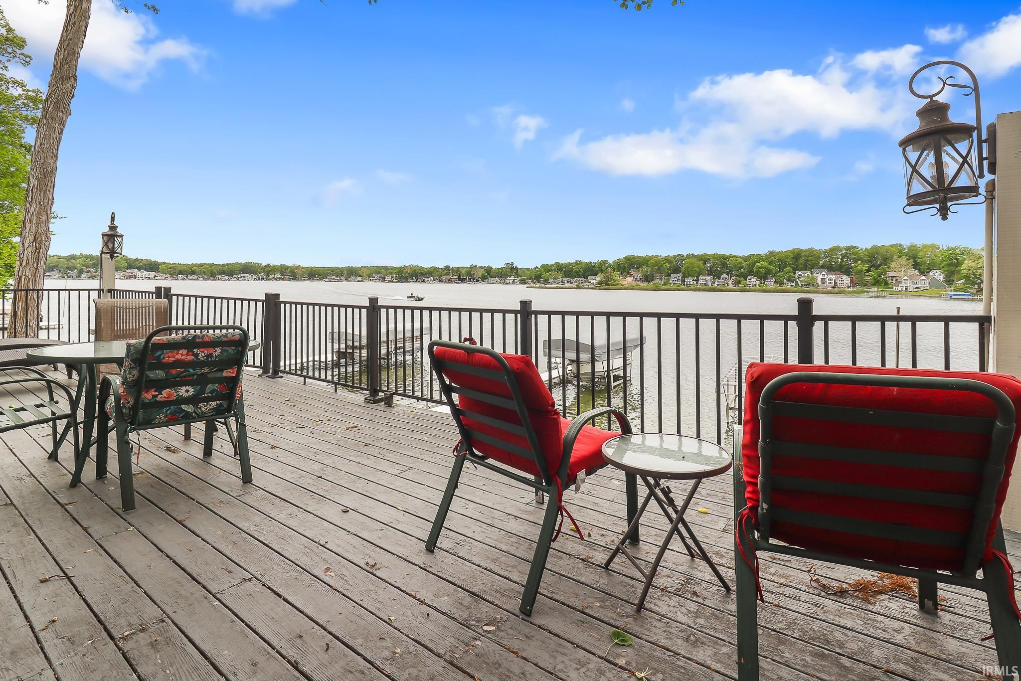 Expansive outdoor deck featuring wood-finish flooring and black metal railing