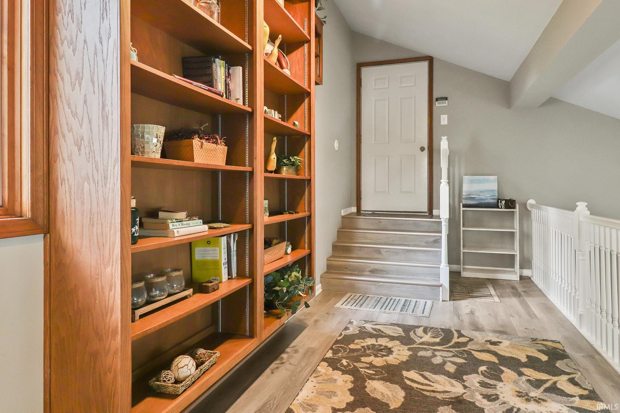 Custom built-in wood shelving provides extensive storage