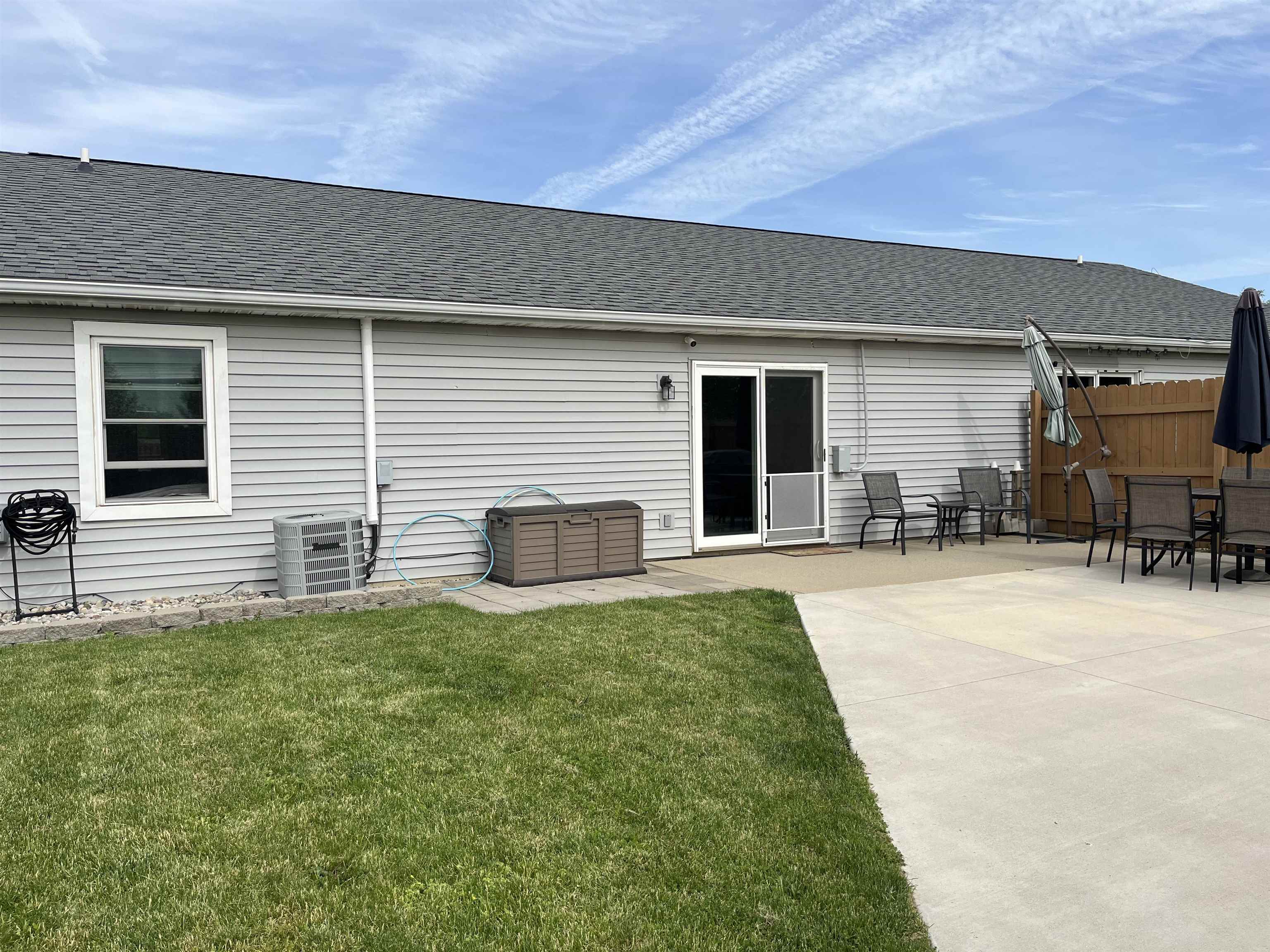 Expansive concrete patio area with direct access to interior via sliding glass door