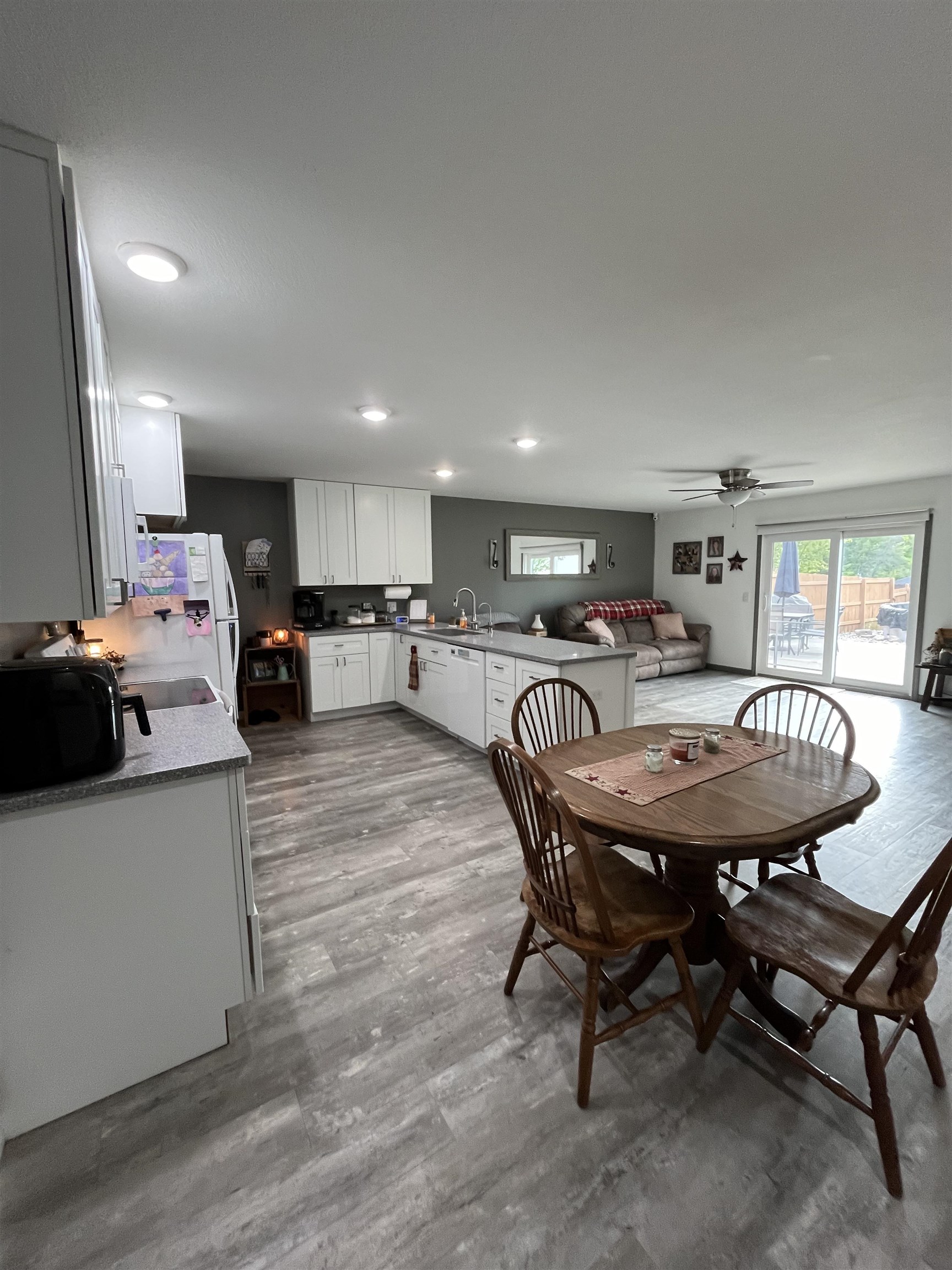 Open concept living area featuring wood-finish flooring