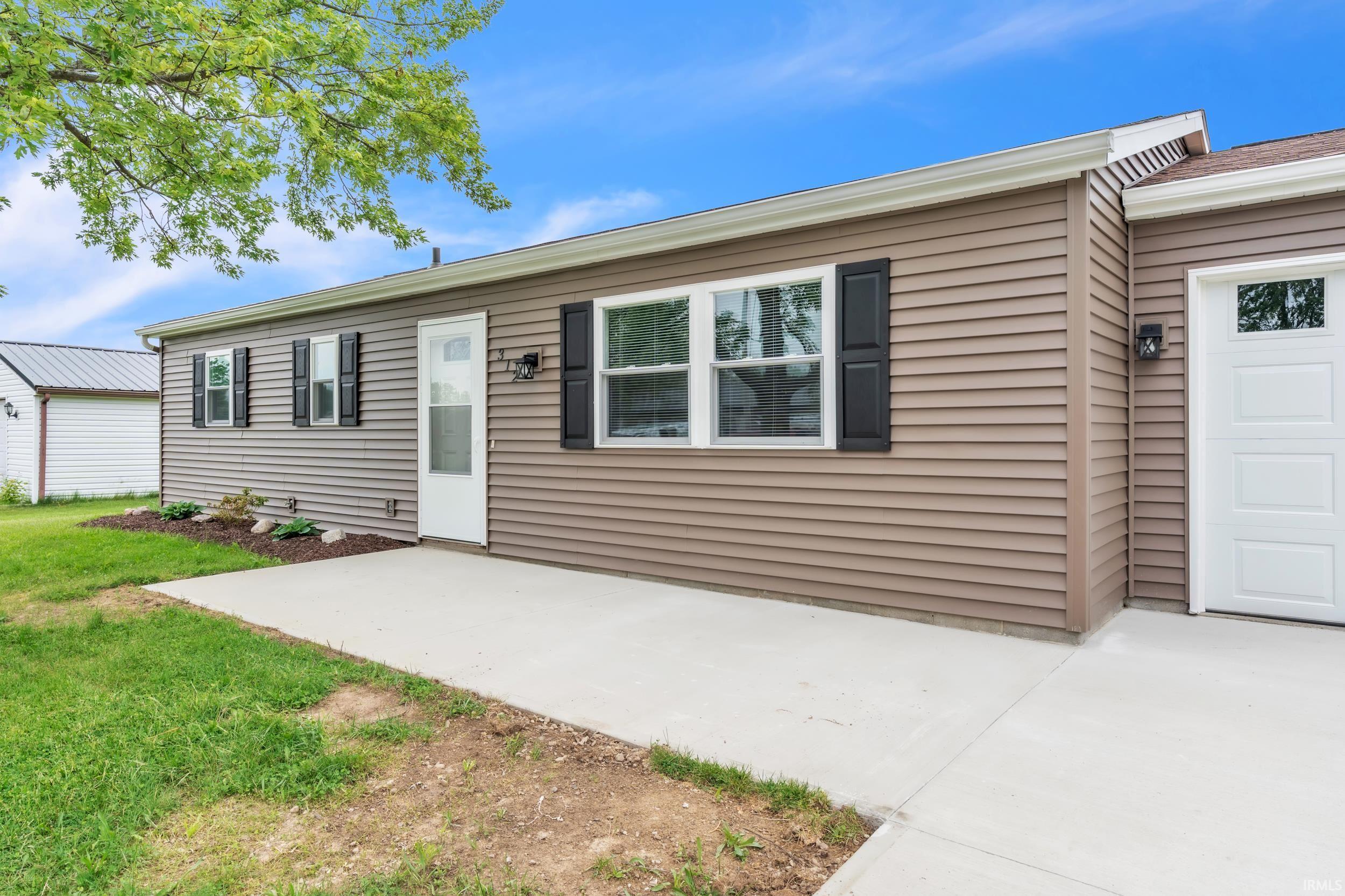 Exterior featuring brown horizontal siding and white trim