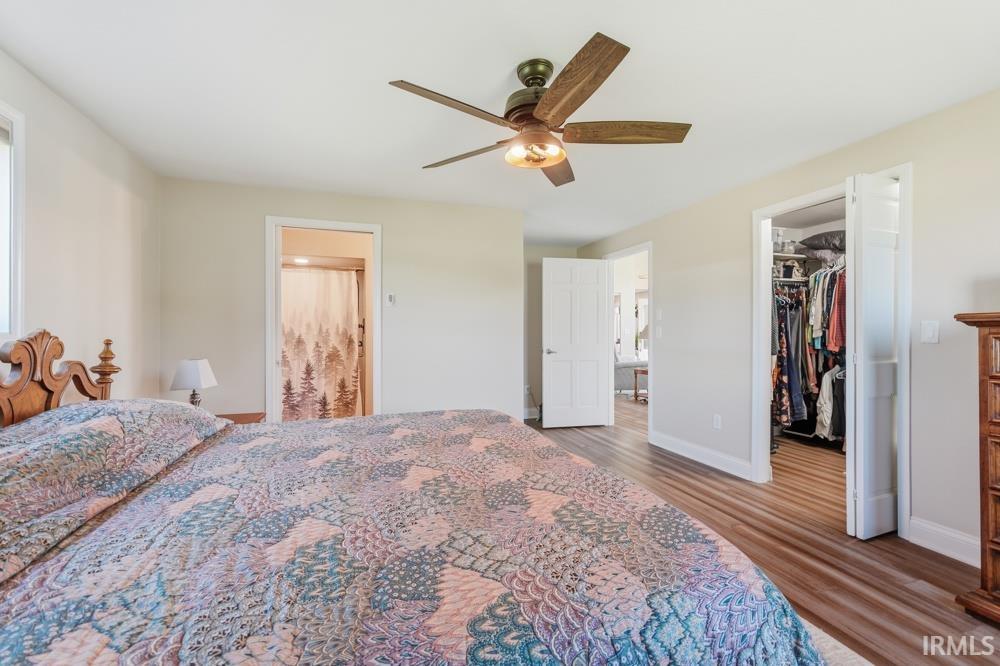 Bedroom featuring wood-finish flooring, a ceiling fan, and light-colored walls