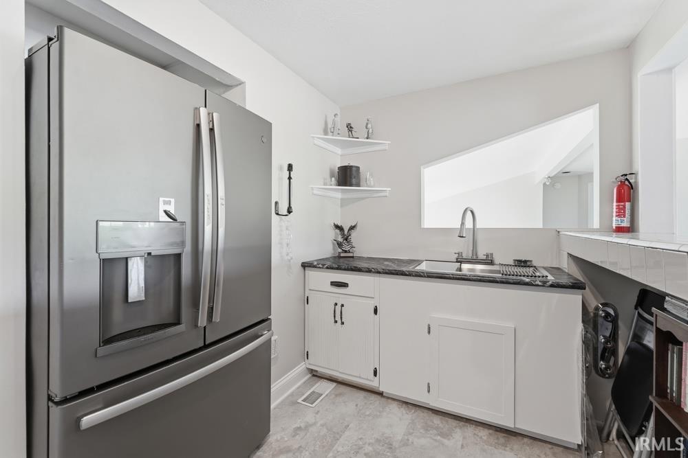 Stainless steel French door refrigerator with an external ice and water dispenser