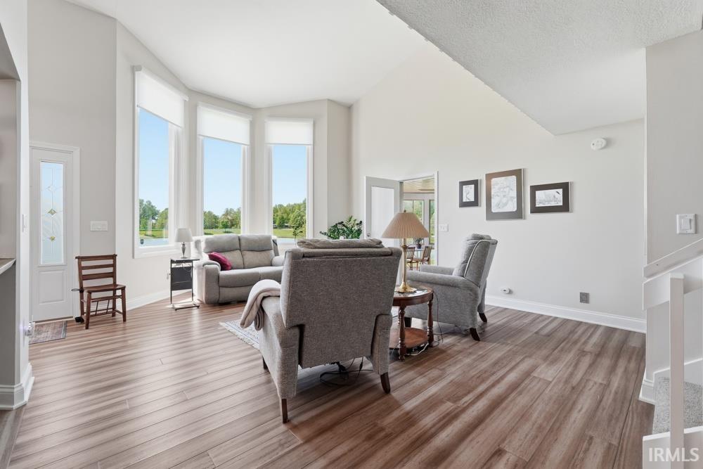 Spacious living area featuring wood-finish flooring and vaulted ceilings