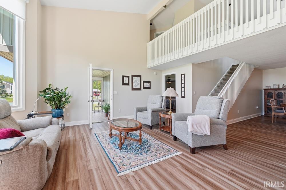 Open-concept living area with vaulted ceilings and wood-finish flooring