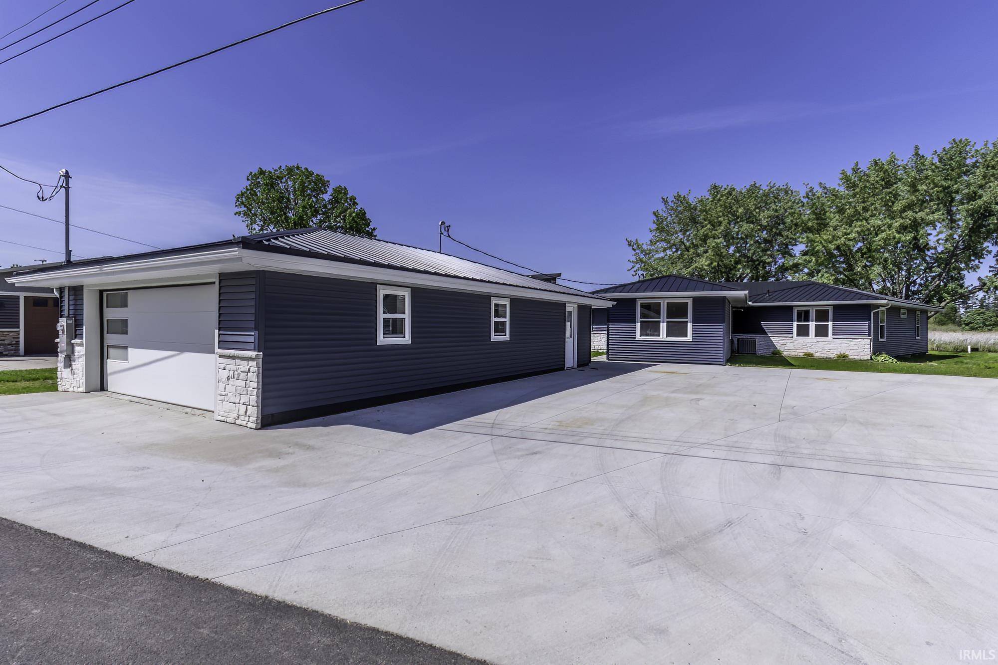 New construction property with a dark blue siding exterior and stone accents