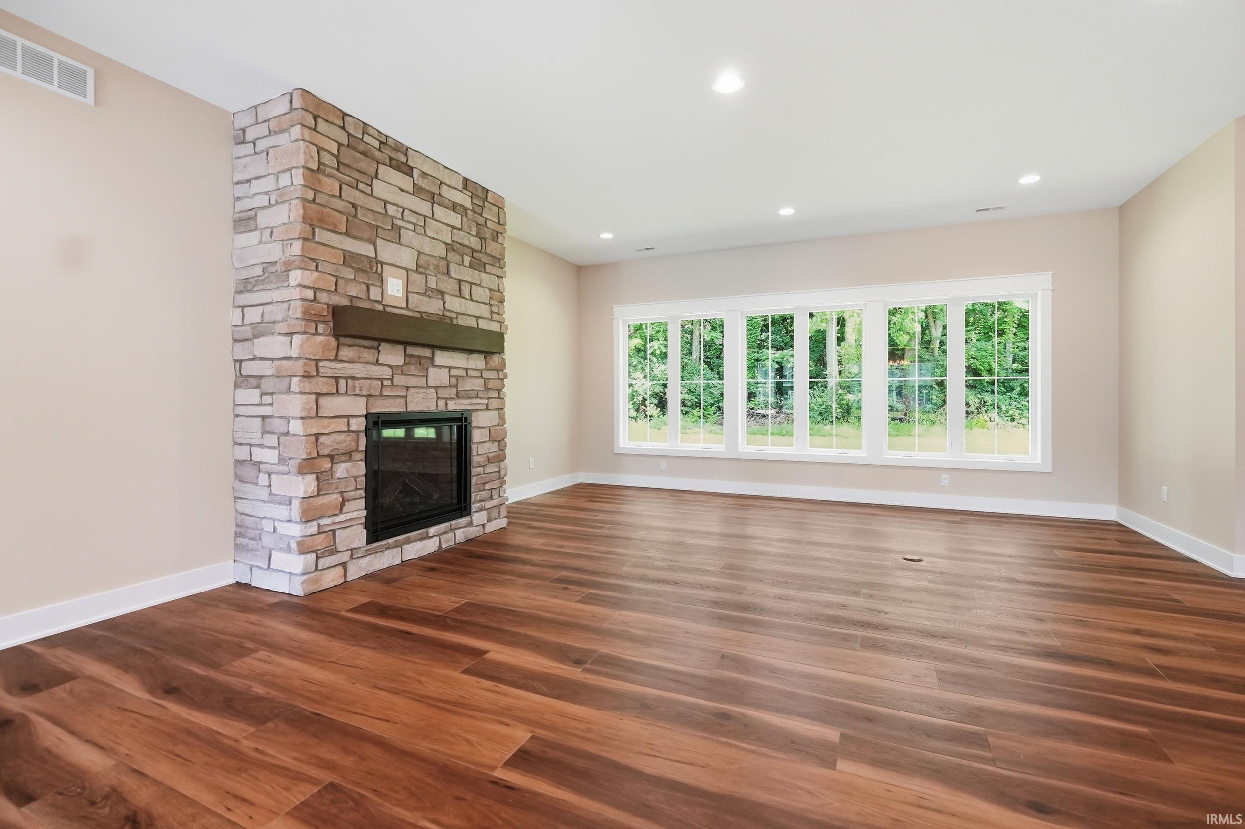 Stone-clad fireplace with a wood mantel