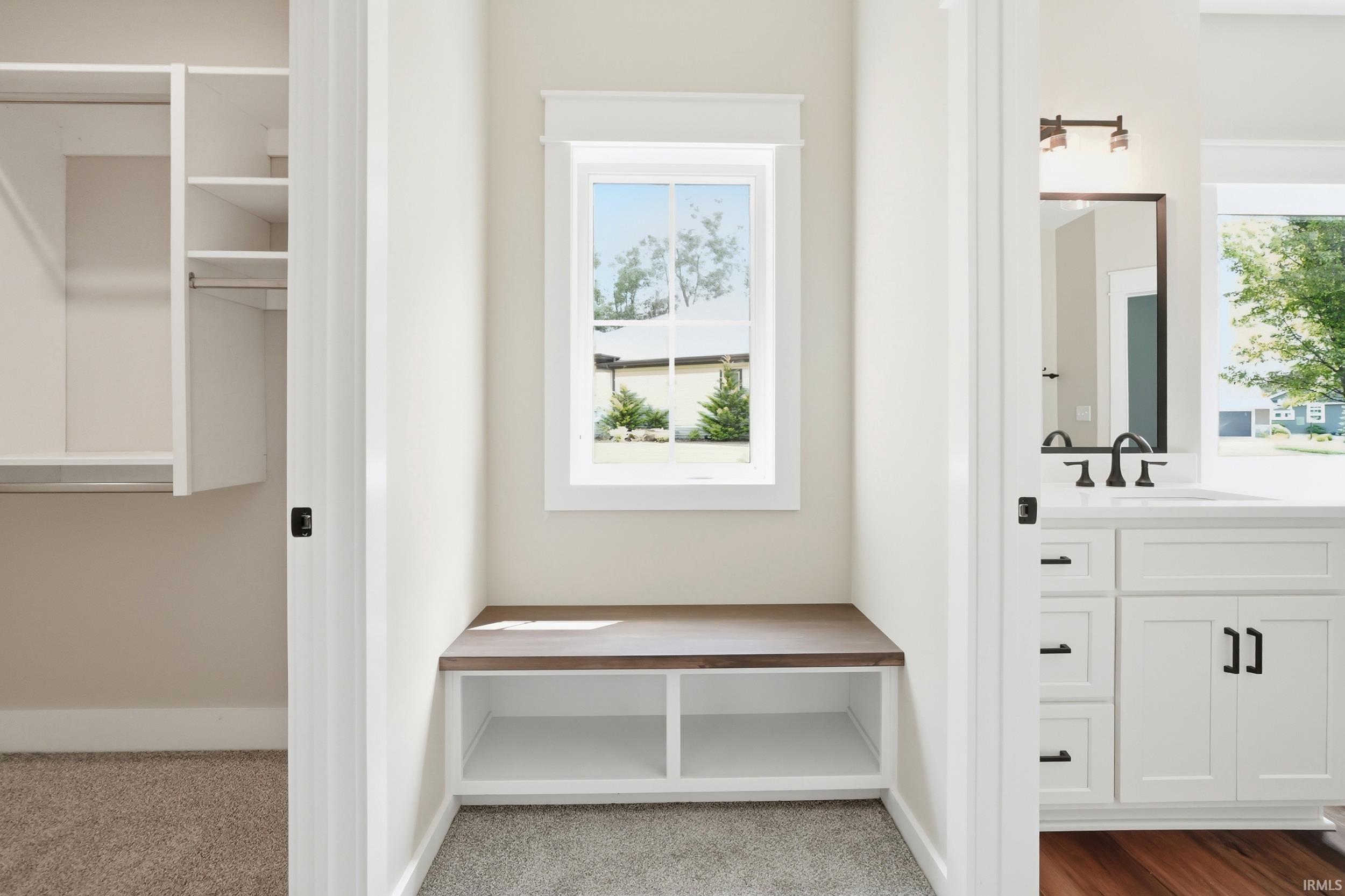 Integrated storage bench with a wood-finish top and open shelving
