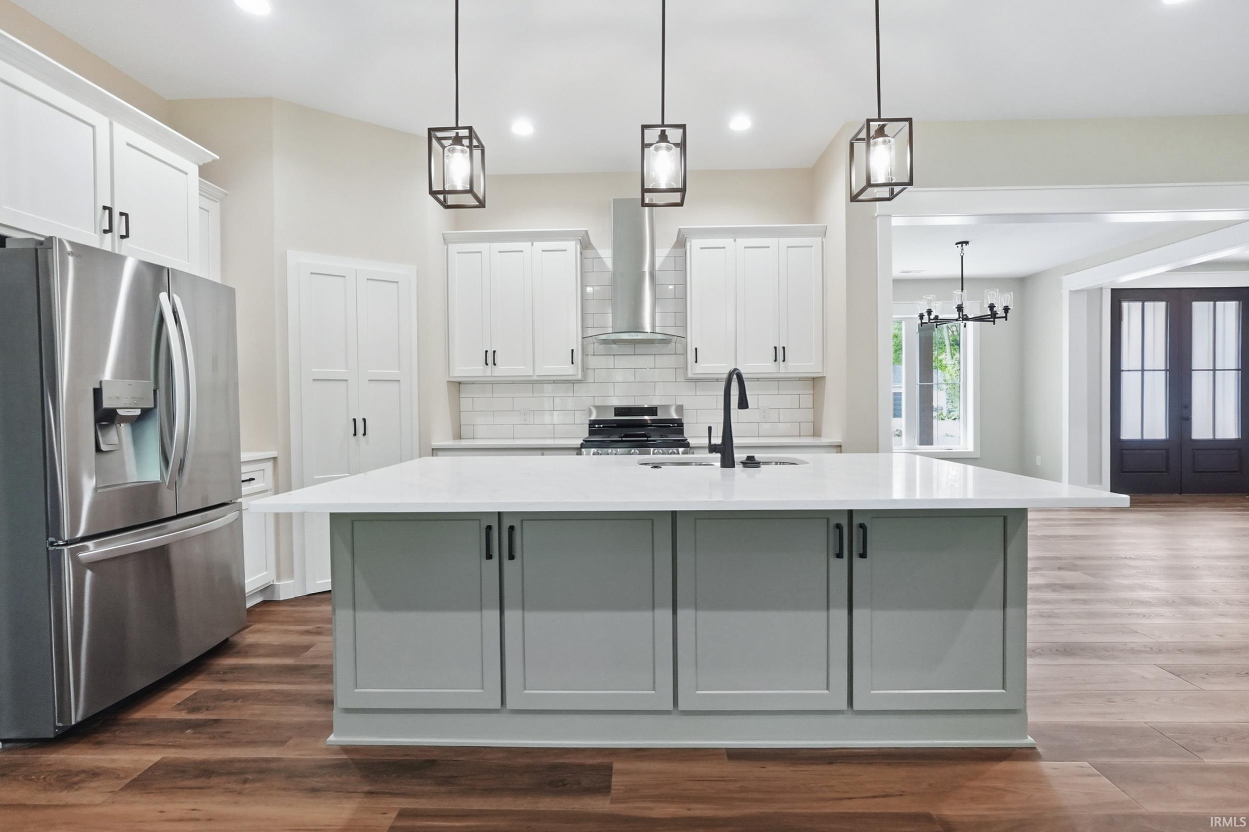 Central kitchen island with a light-toned countertop and pendant lighting