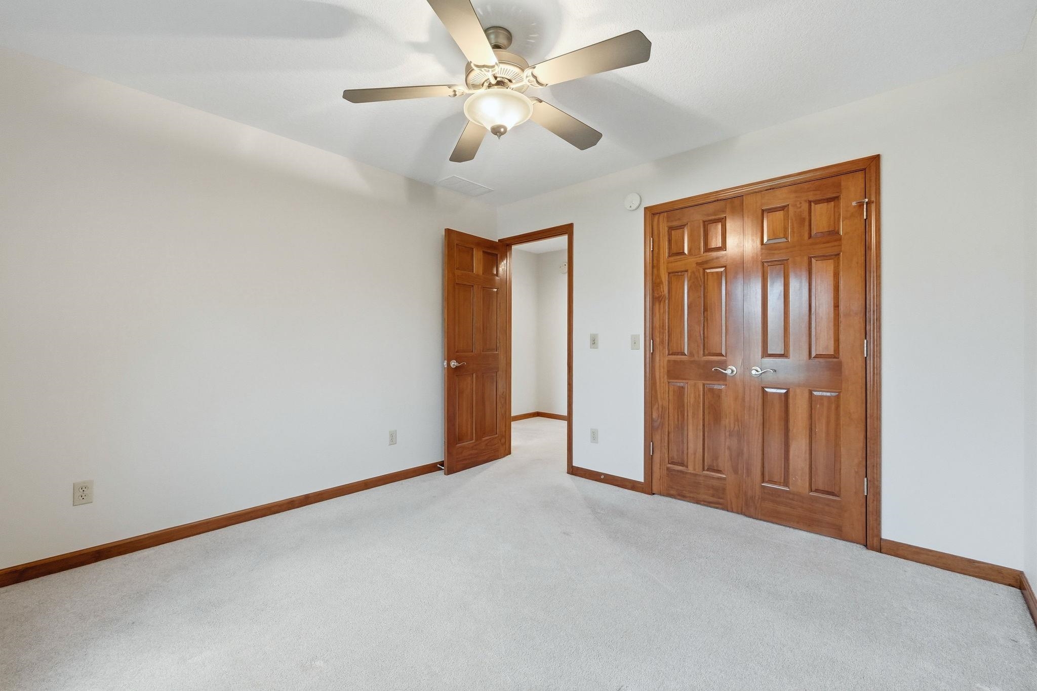 Neutral wall finishes complement the light-toned carpeting