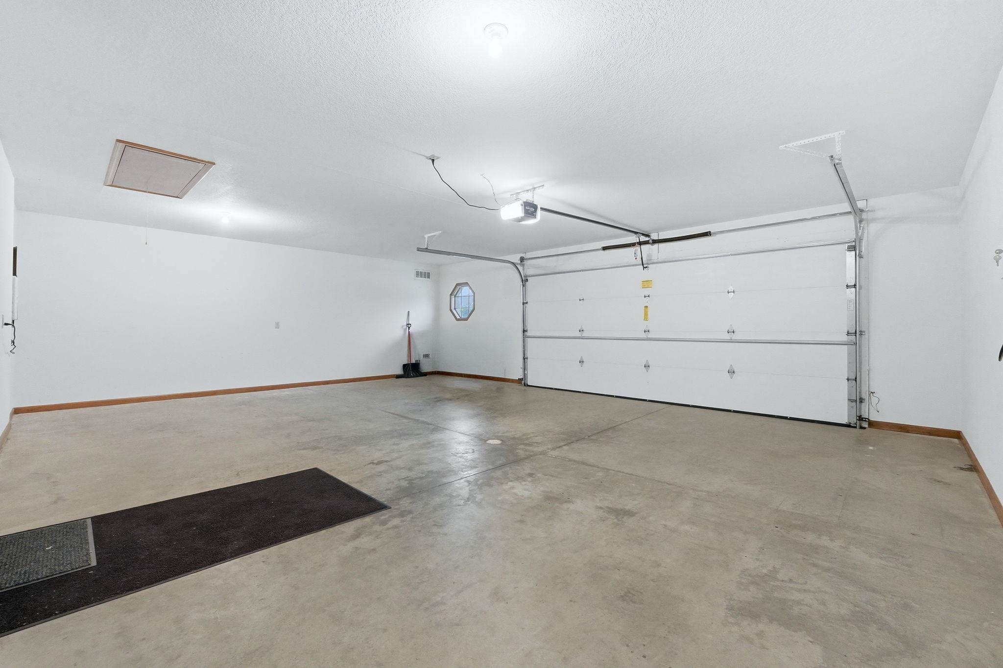 Spacious garage with concrete flooring and white walls