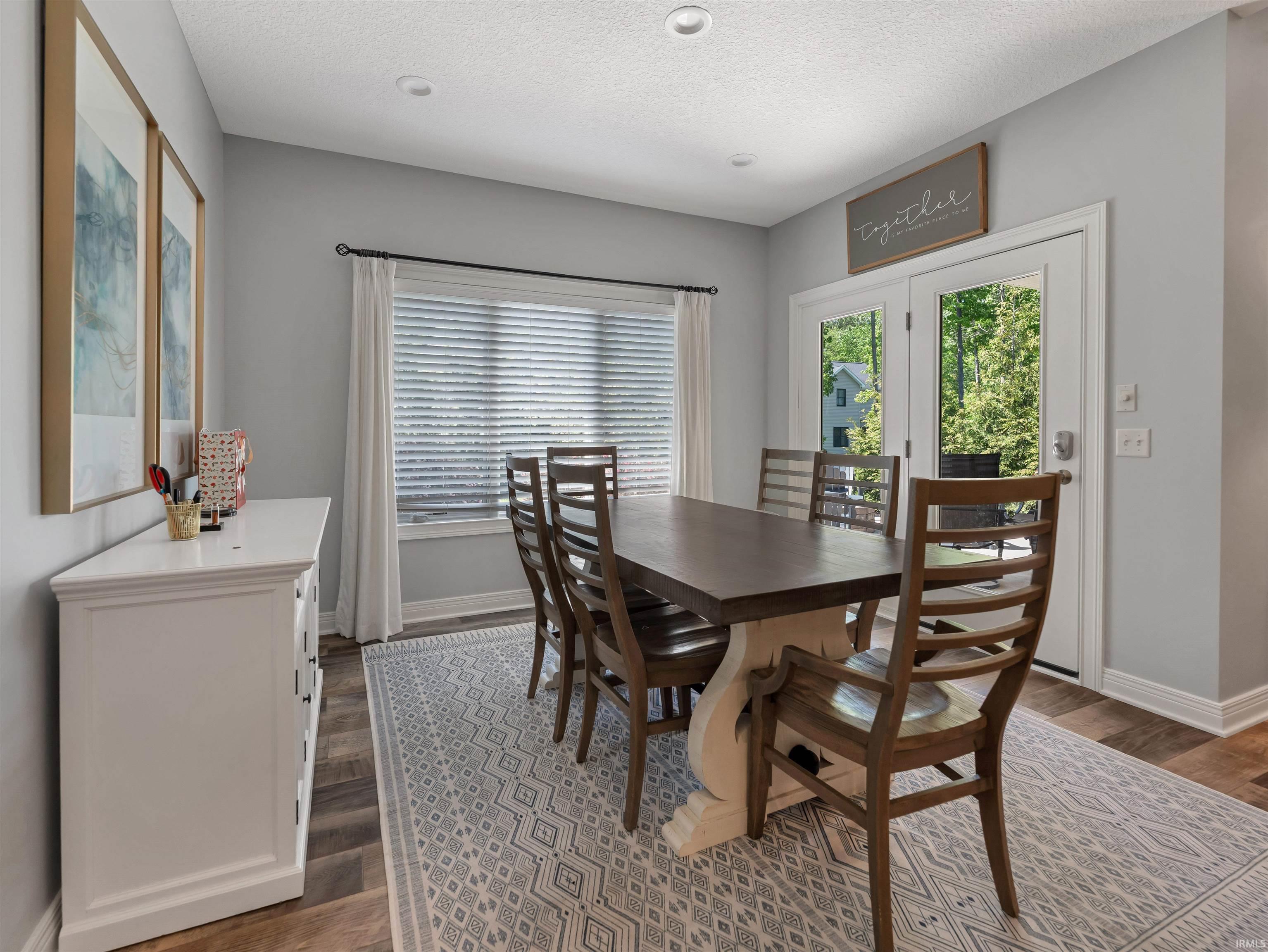 Dining area featuring wood-finish flooring and recessed lighting