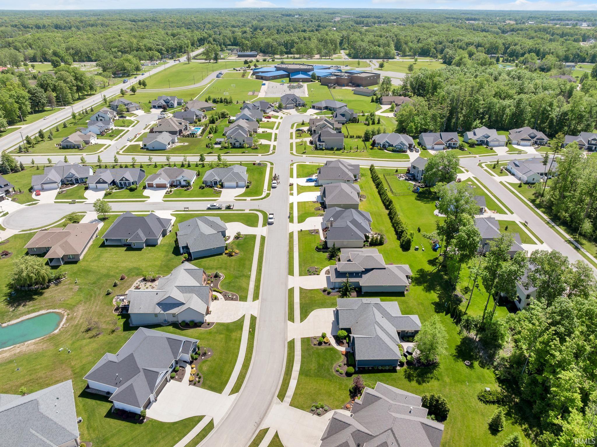 Expansive neighborhood with paved streets and manicured green spaces
