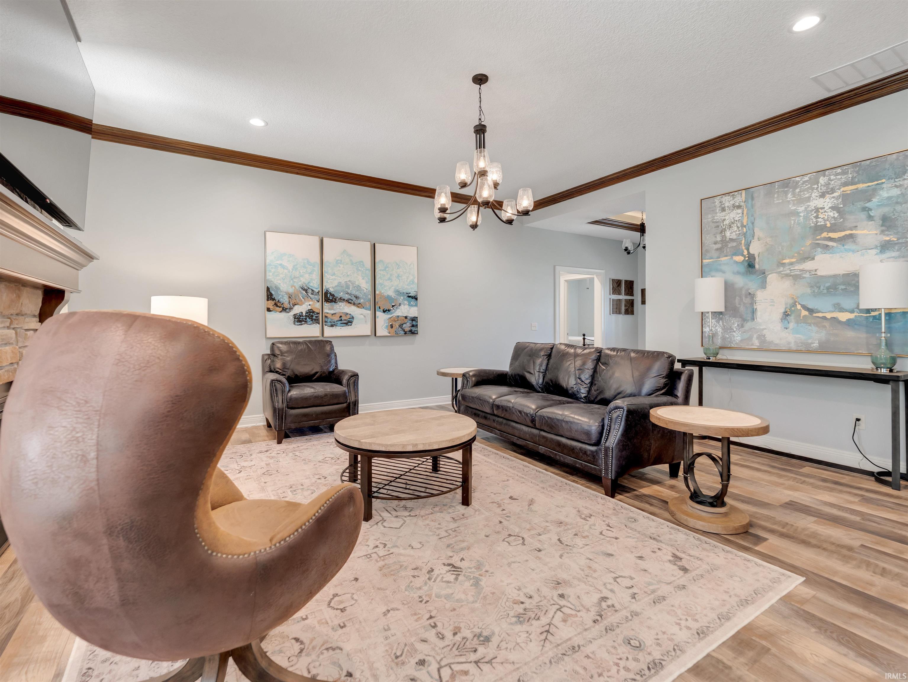 Spacious living area featuring wood-finish flooring and light-toned walls