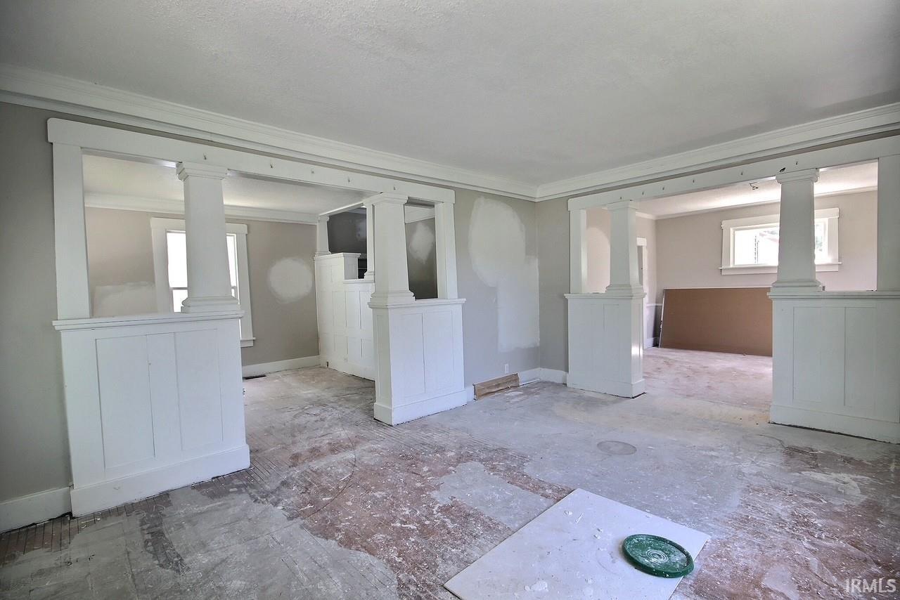 Interior space featuring architectural columns and half-walls defining room transitions