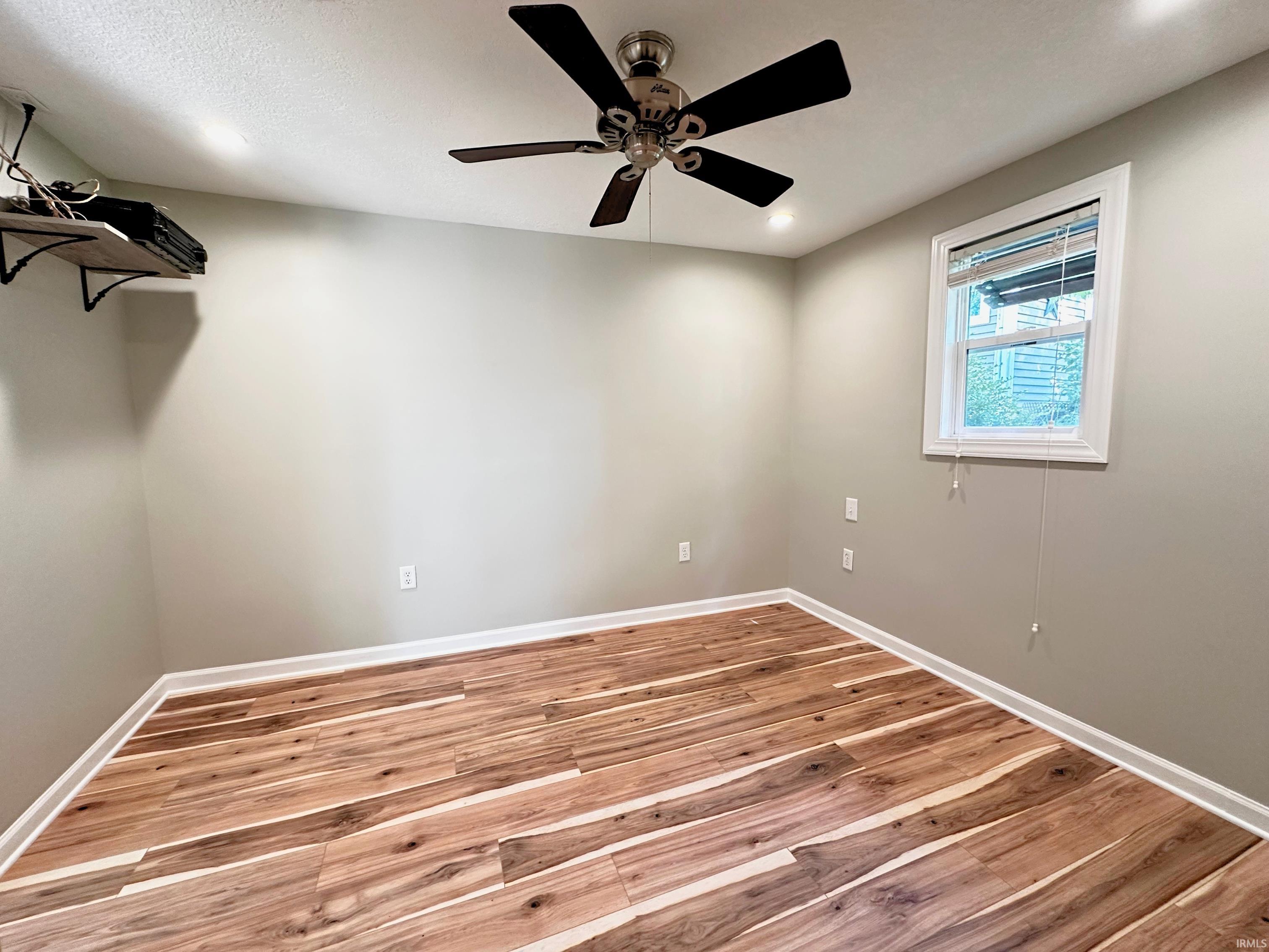 Wood flooring, neutral wall paint, and a ceiling fan with integrated lighting. Upgrades galore!