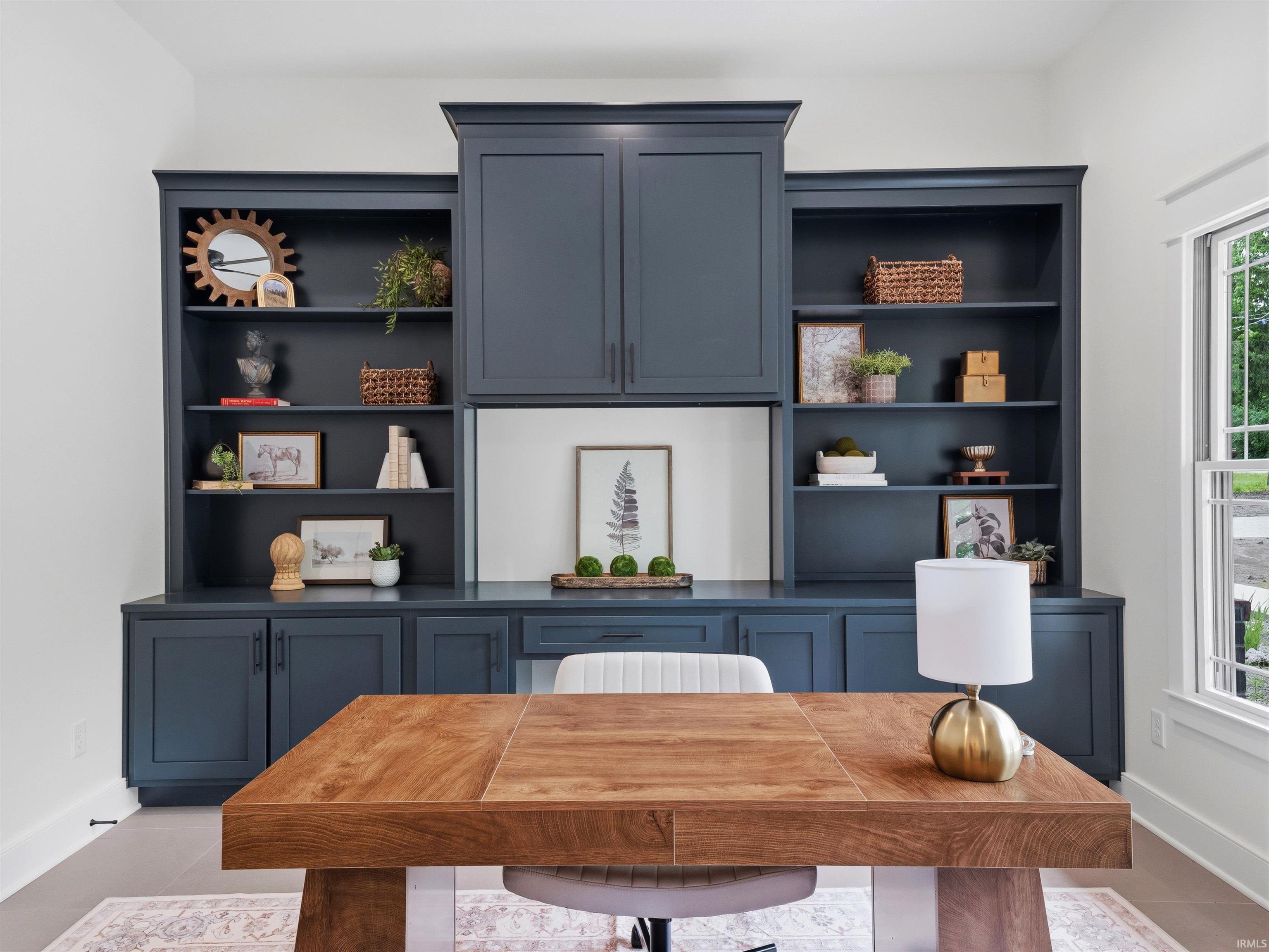Built-in cabinetry in a deep blue finish, featuring open shelving and closed storage