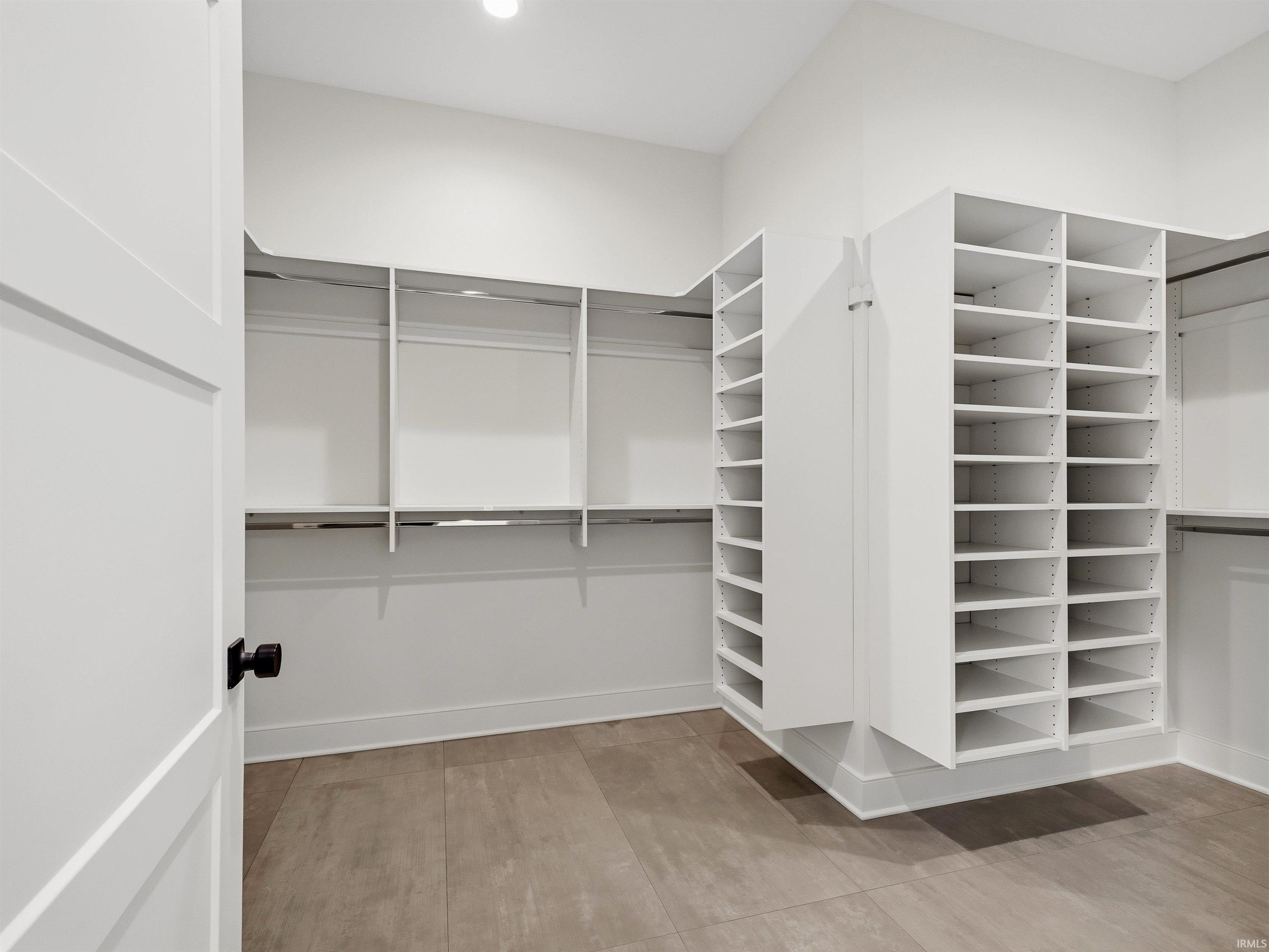 Custom closet system featuring extensive shelving and hanging rods