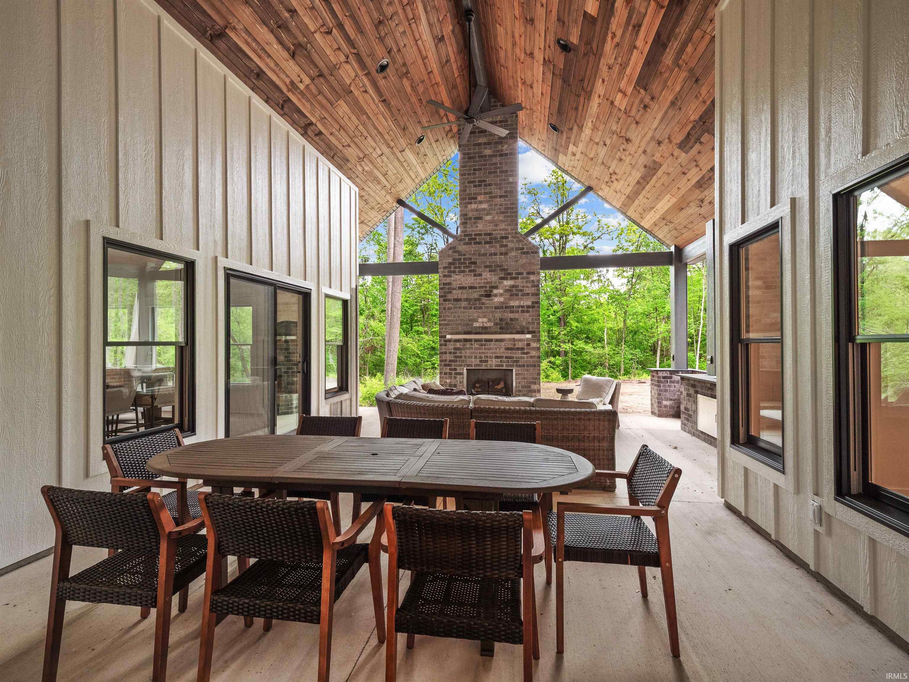 Expansive outdoor living area featuring a vaulted wood-paneled ceiling