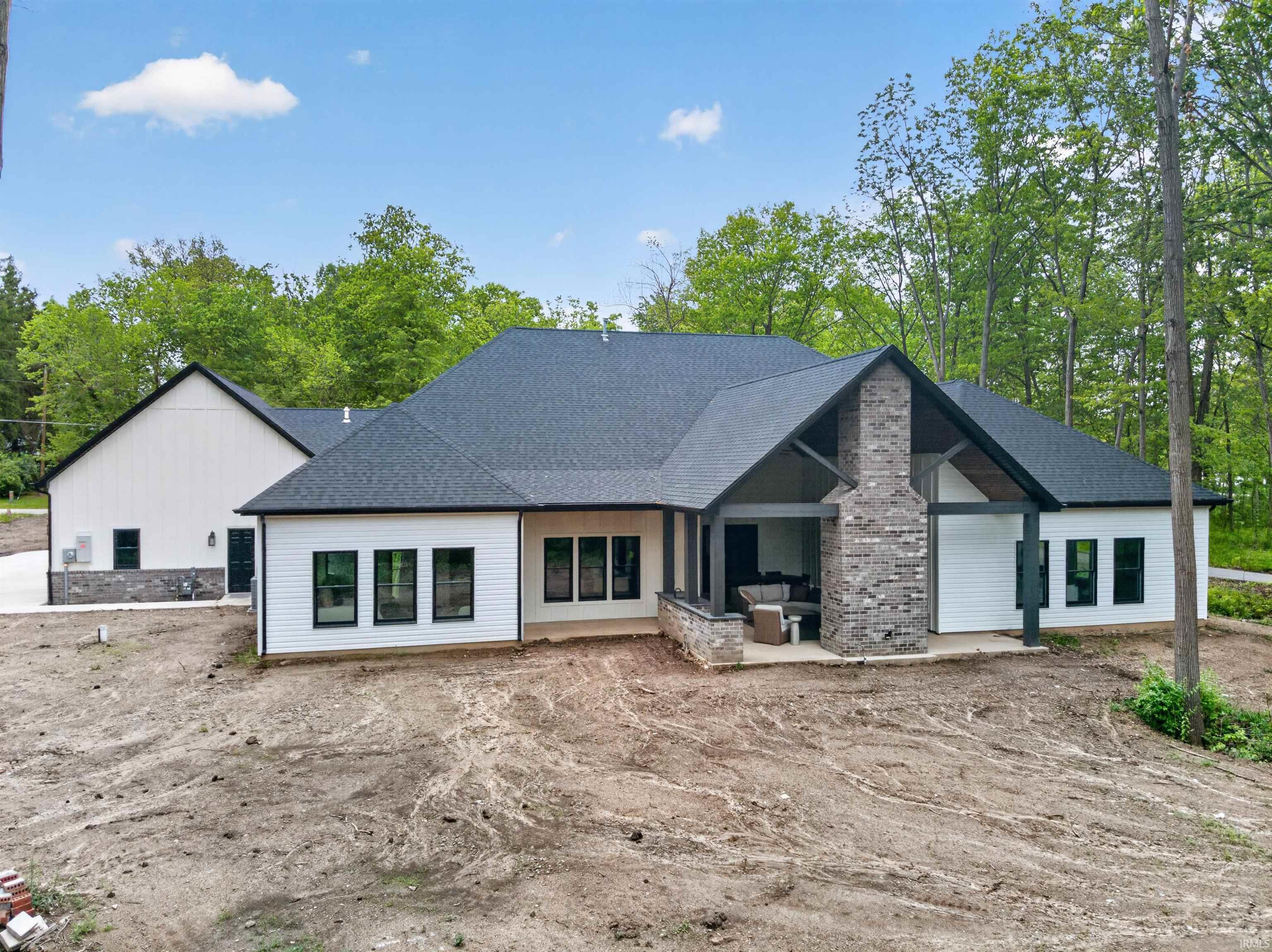 Modern farmhouse architecture featuring white siding with black trim windows