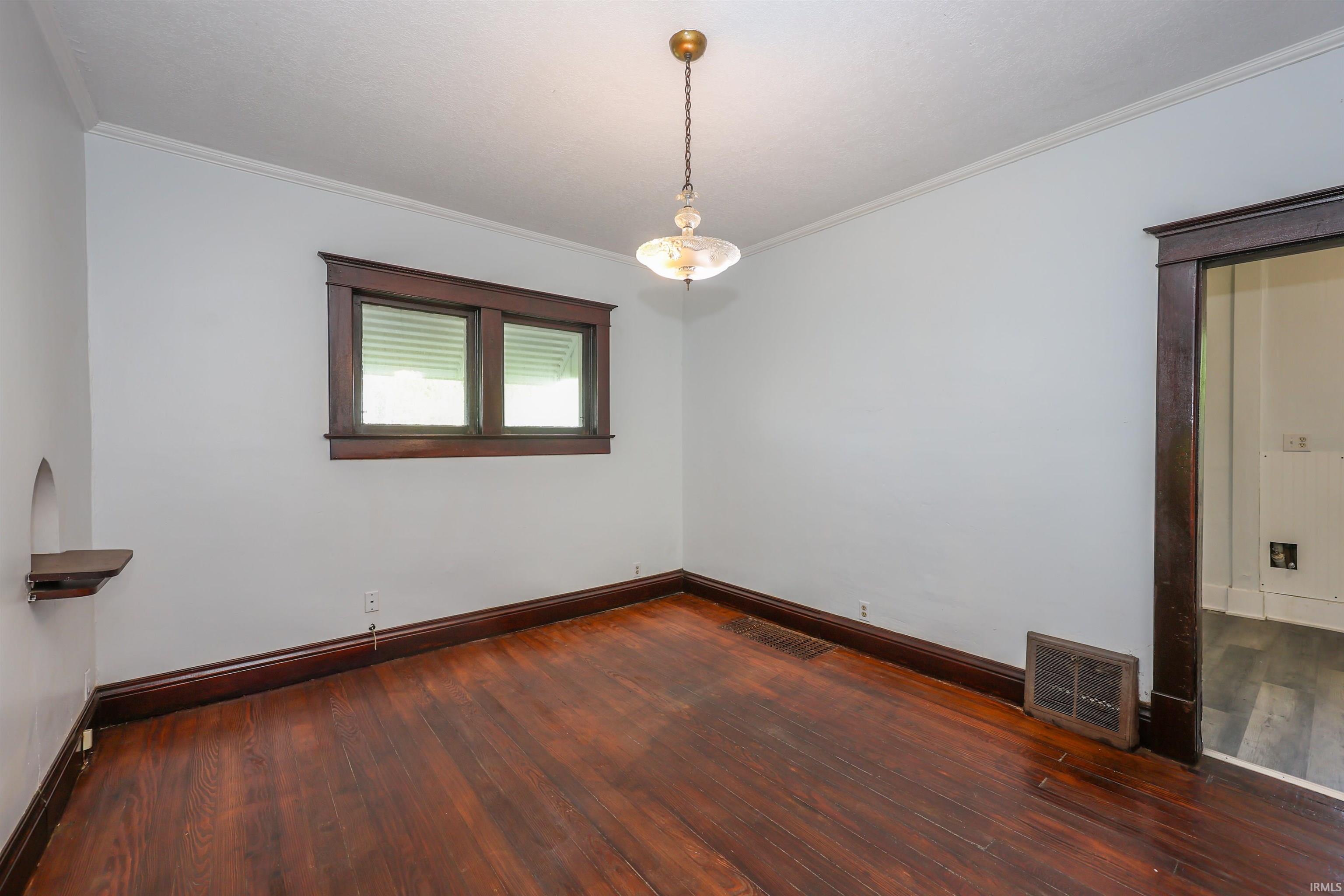 Hardwood-finish flooring with dark wood baseboards