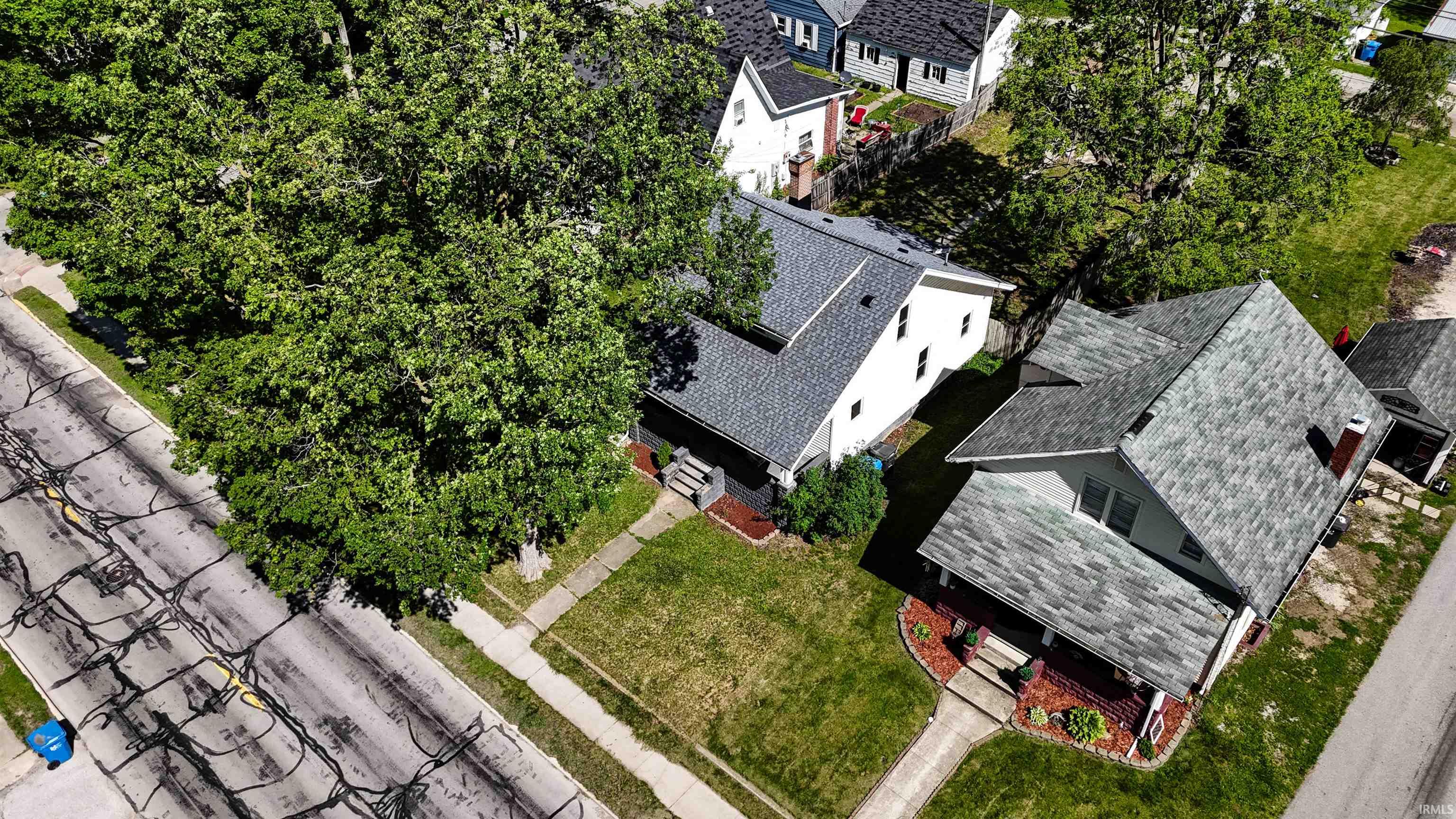 Front yard with established landscaping and a paved walkway leading to the entrance