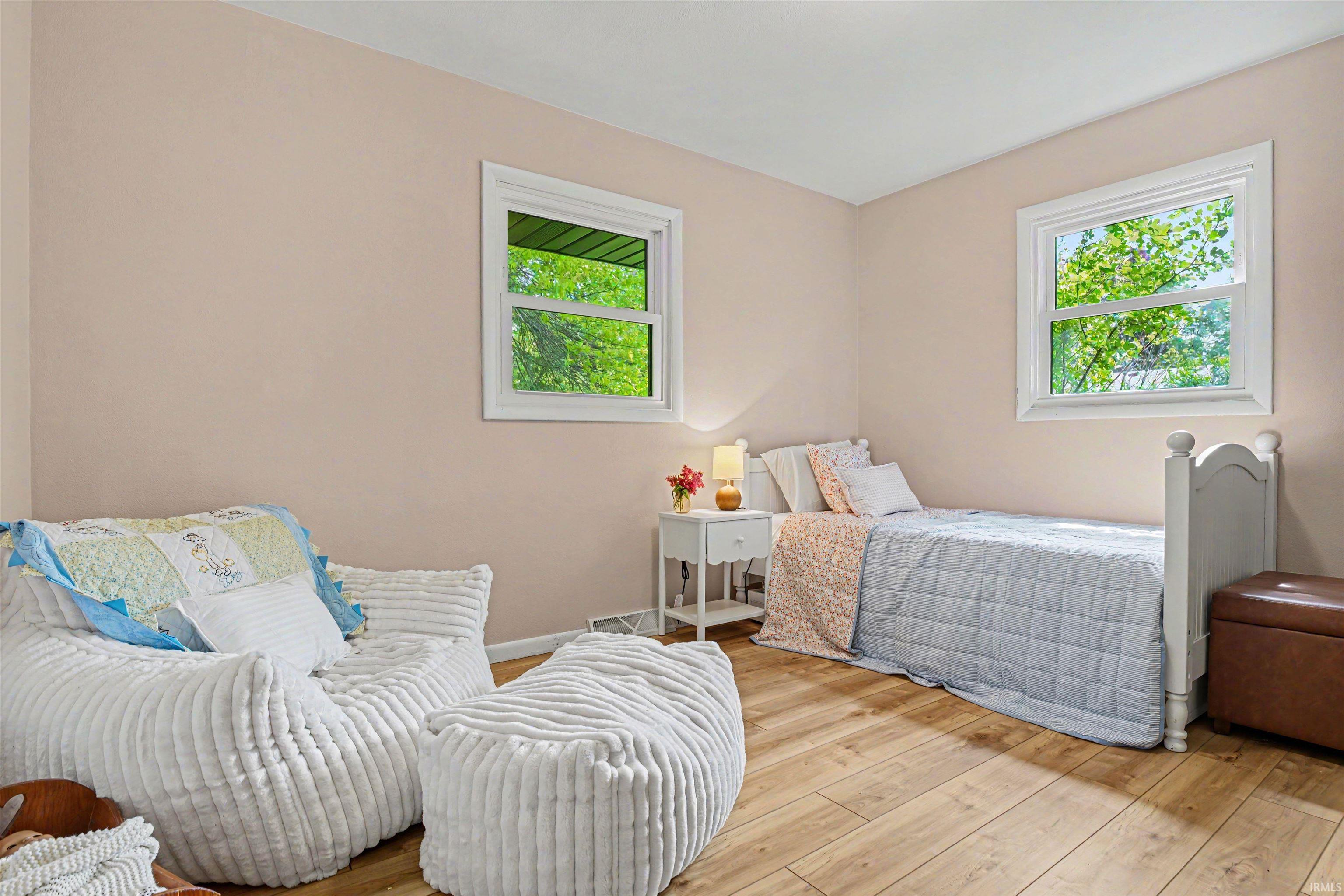 Light-toned wood-finish flooring complements the neutral wall color in this room