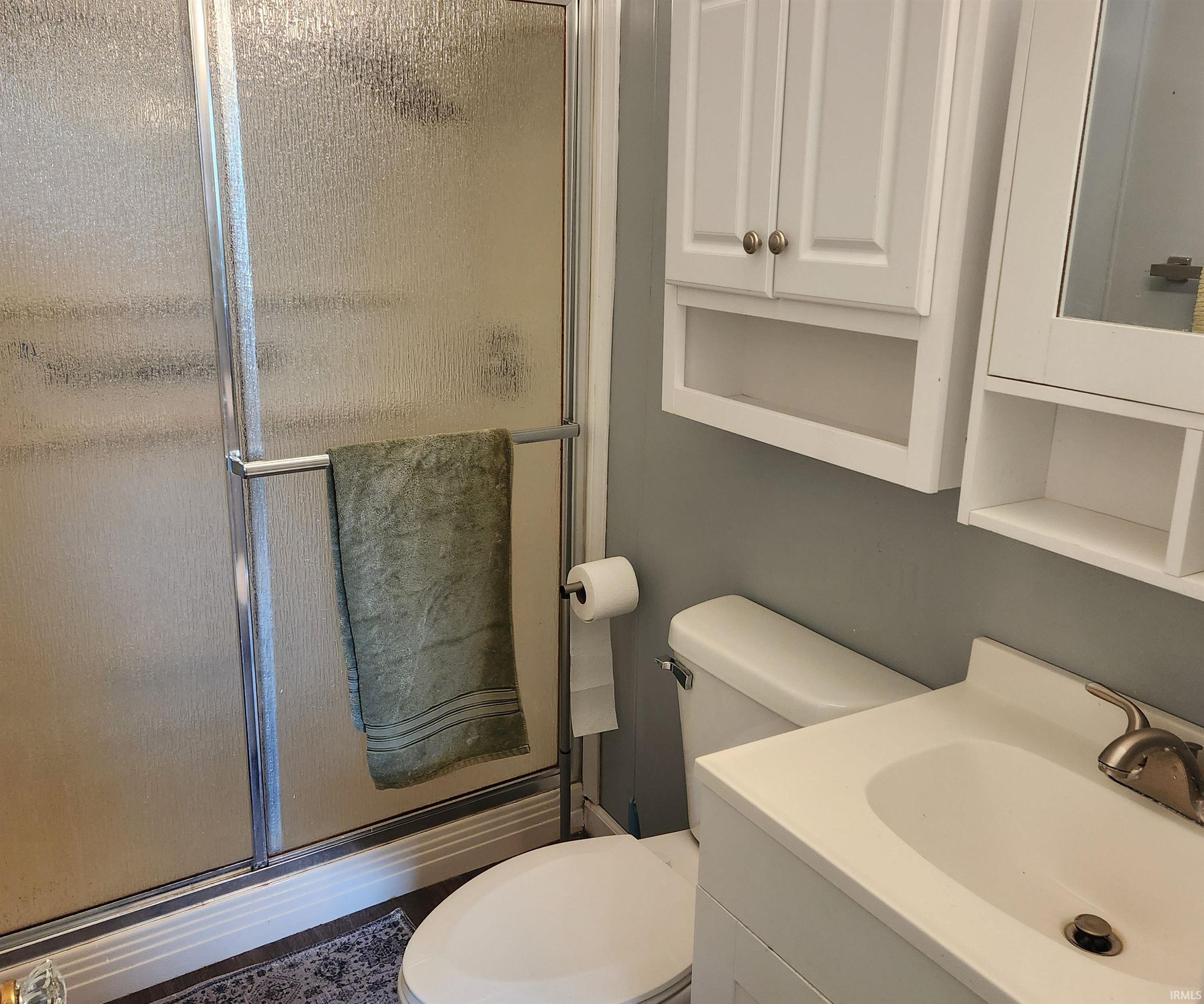 Shower with textured glass enclosure and chrome hardware