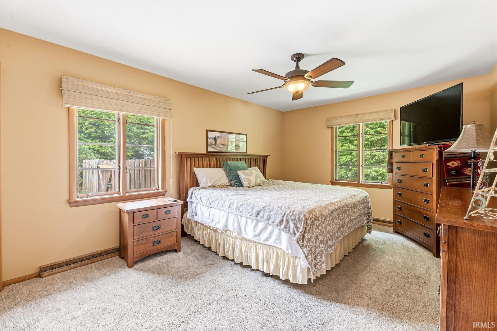 Bedroom featuring soft neutral wall tones and light-colored carpet flooring
