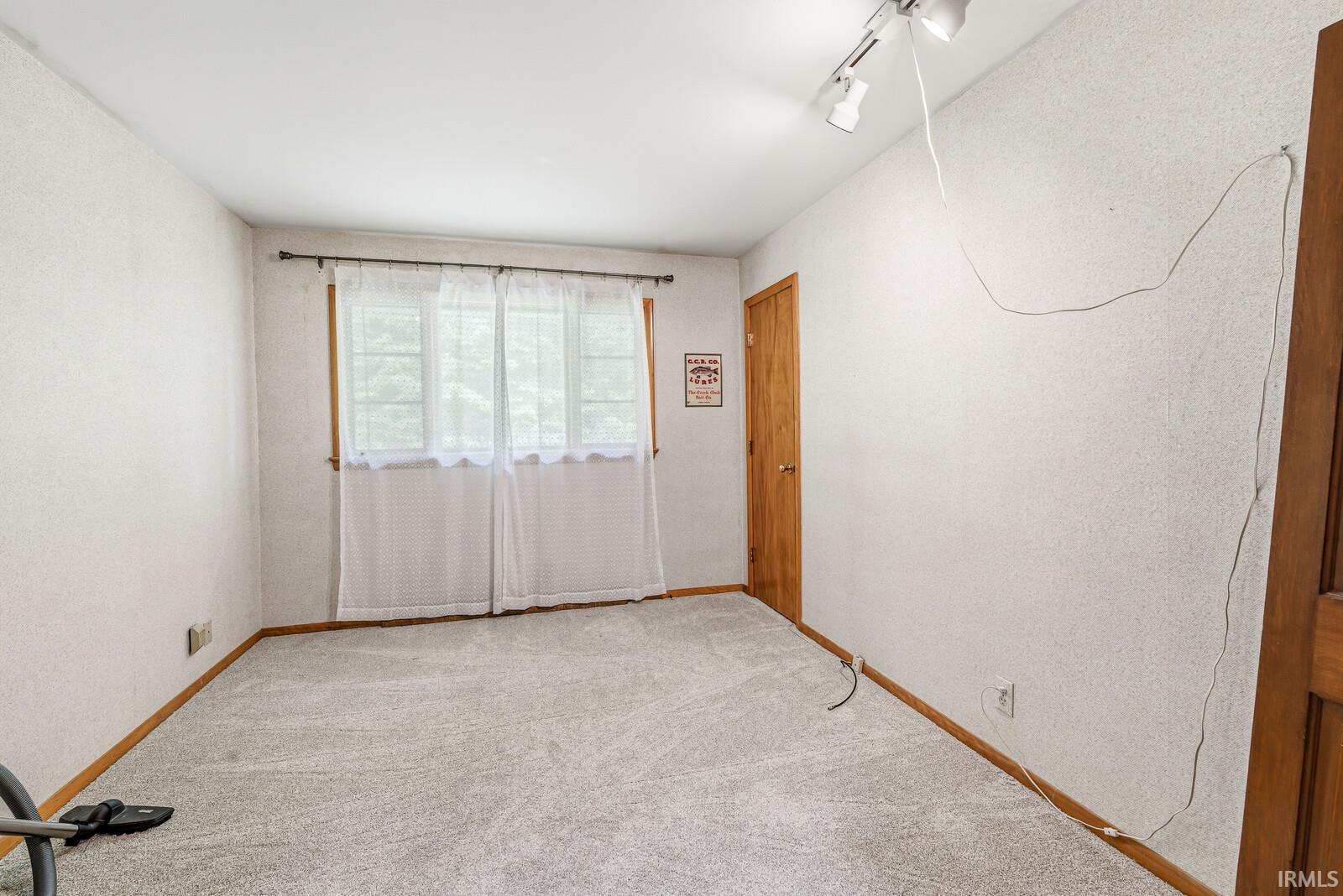 Light gray carpeting with wood baseboards