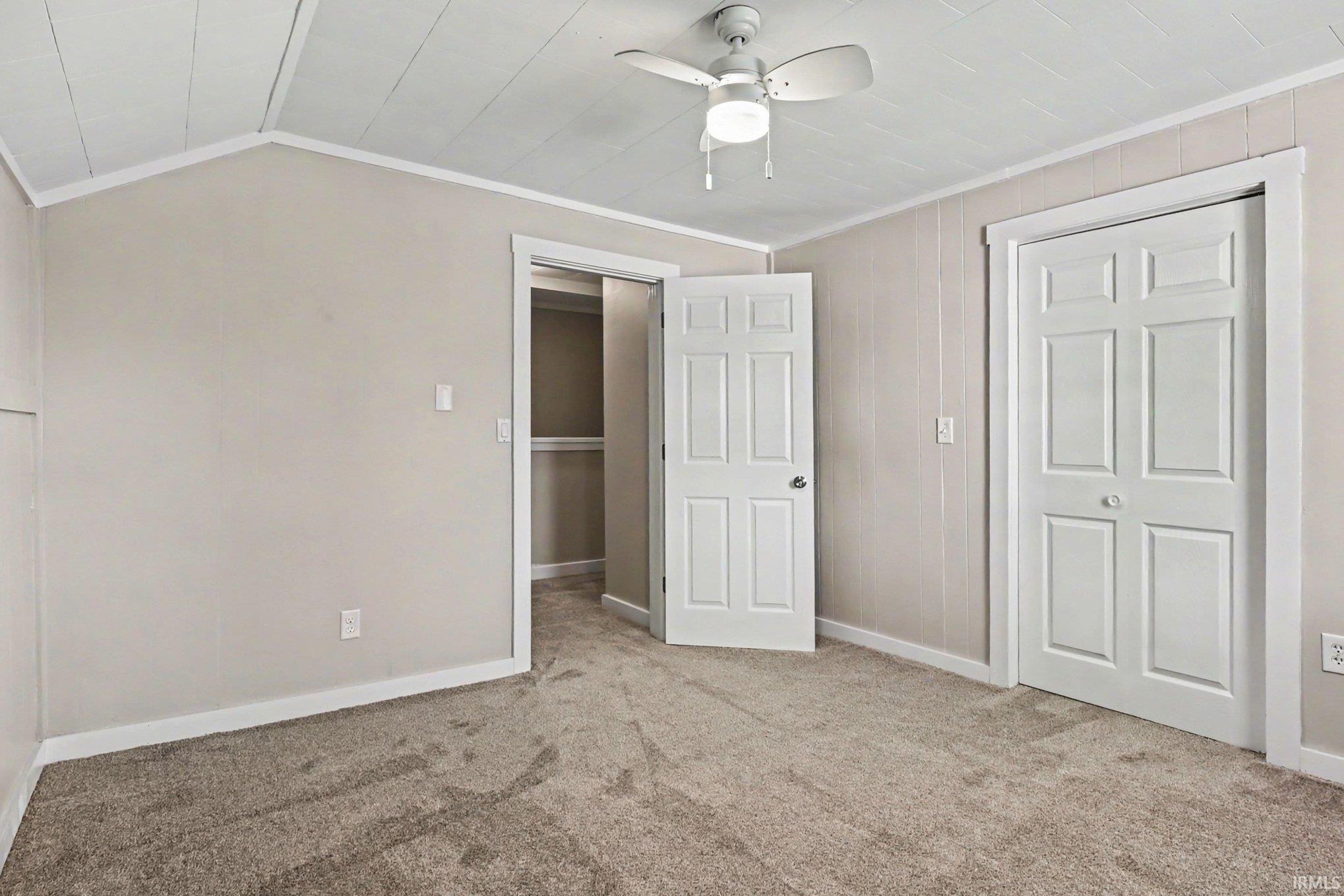 Room featuring neutral-toned walls, white trim, and a textured ceiling