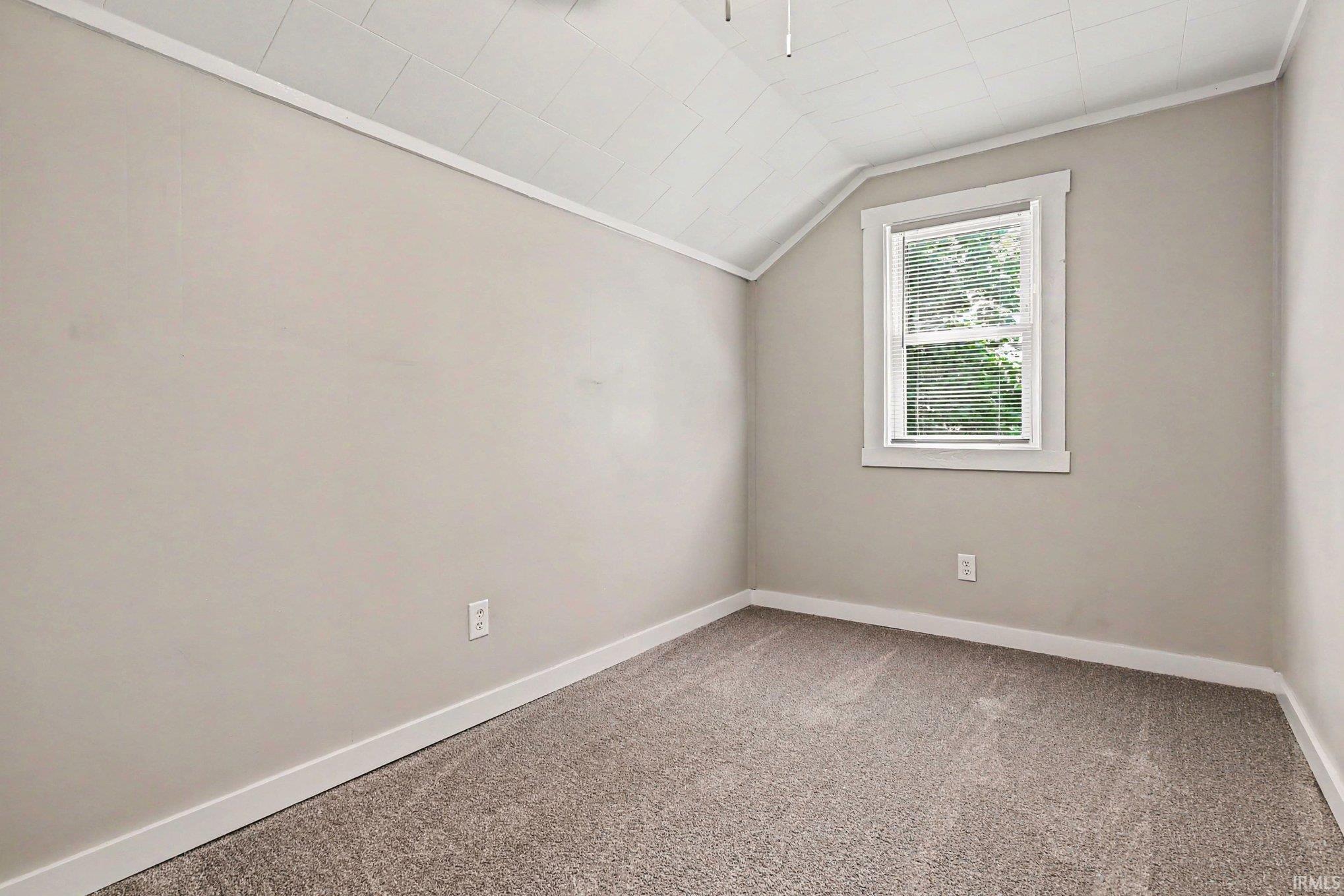 Neutral tone walls, ceiling fan, white trim, window with blinds, and carpeted flooring
