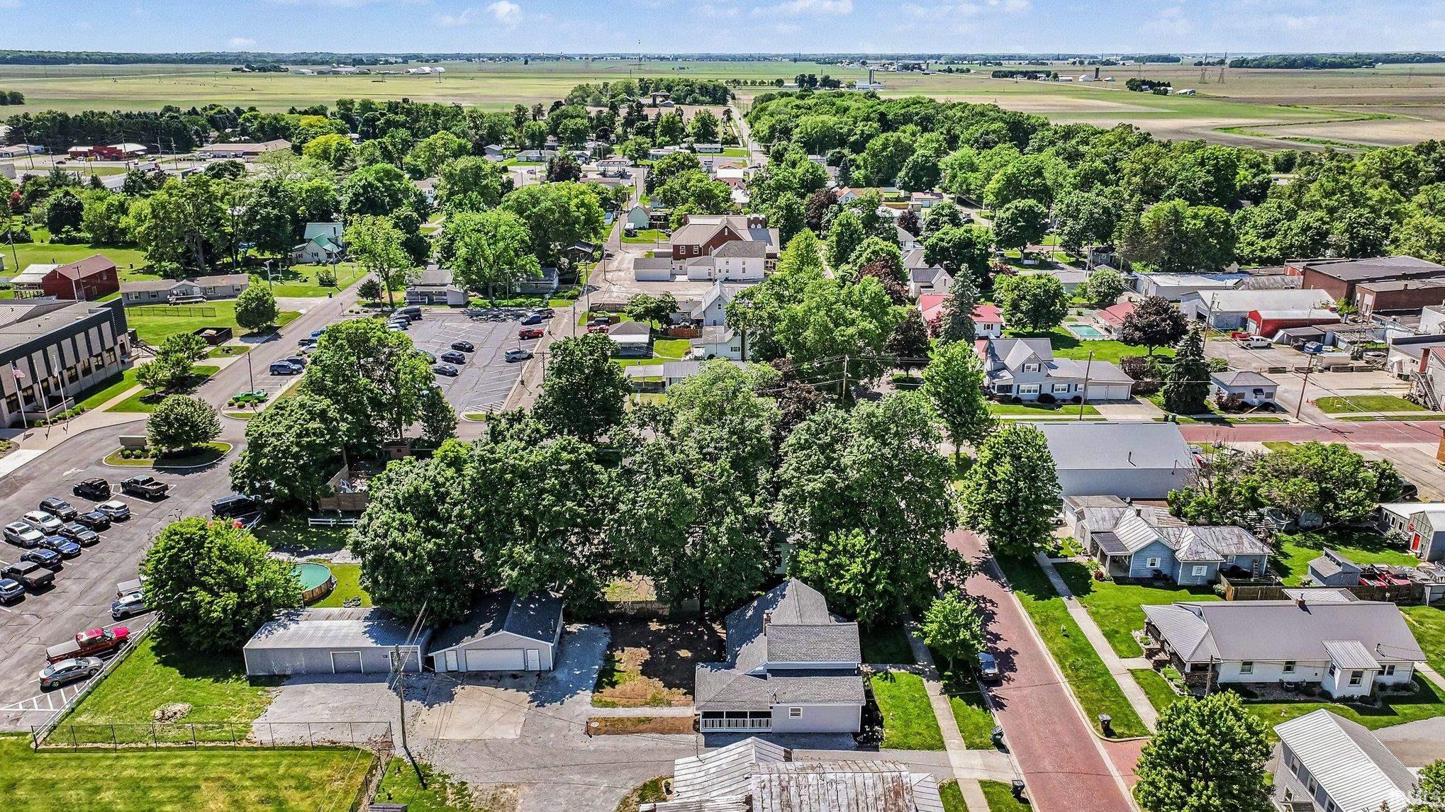 Aerial perspective showcasing a residential area interspersed with mature trees and green spaces