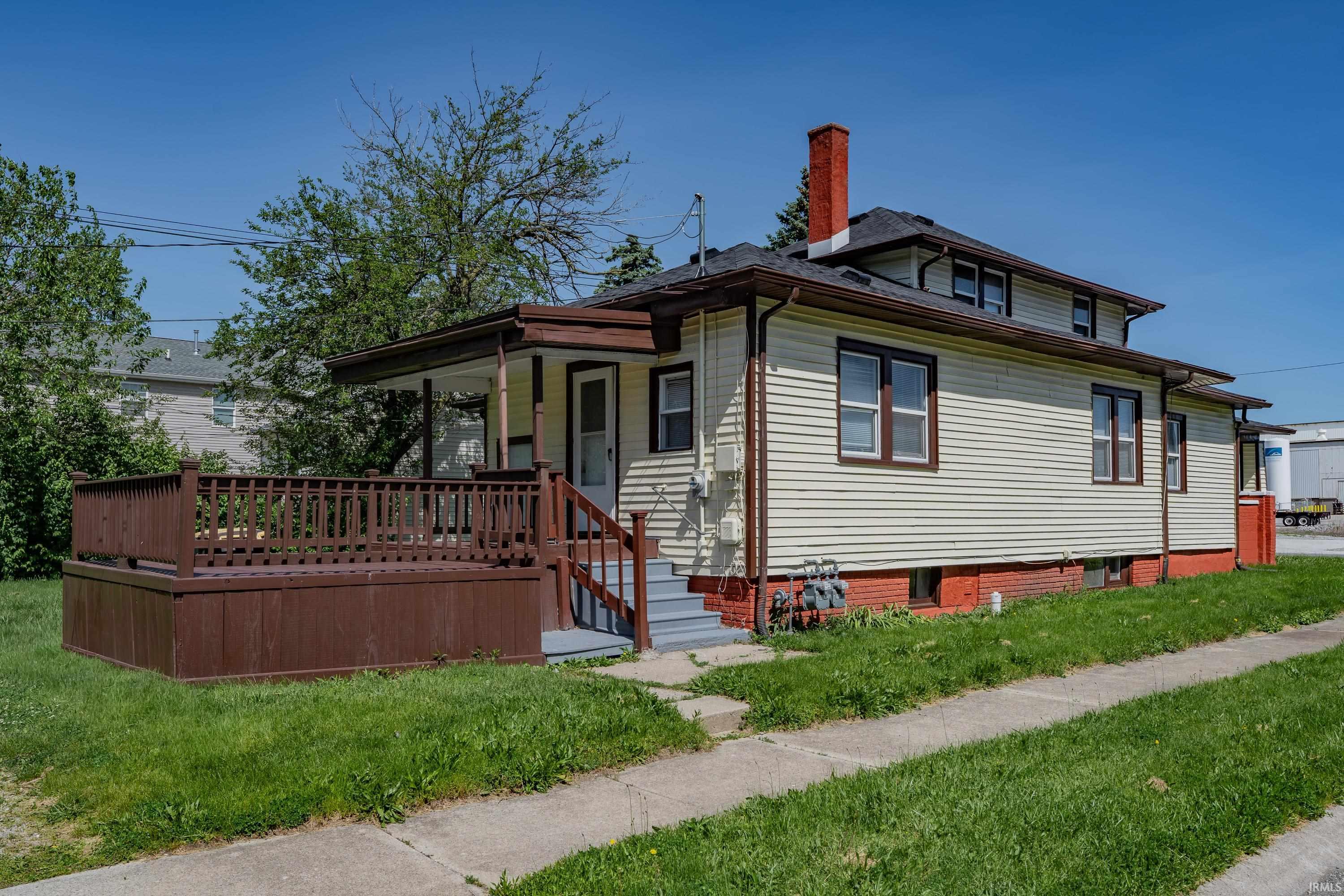 Siding exterior with a covered porch and front deck