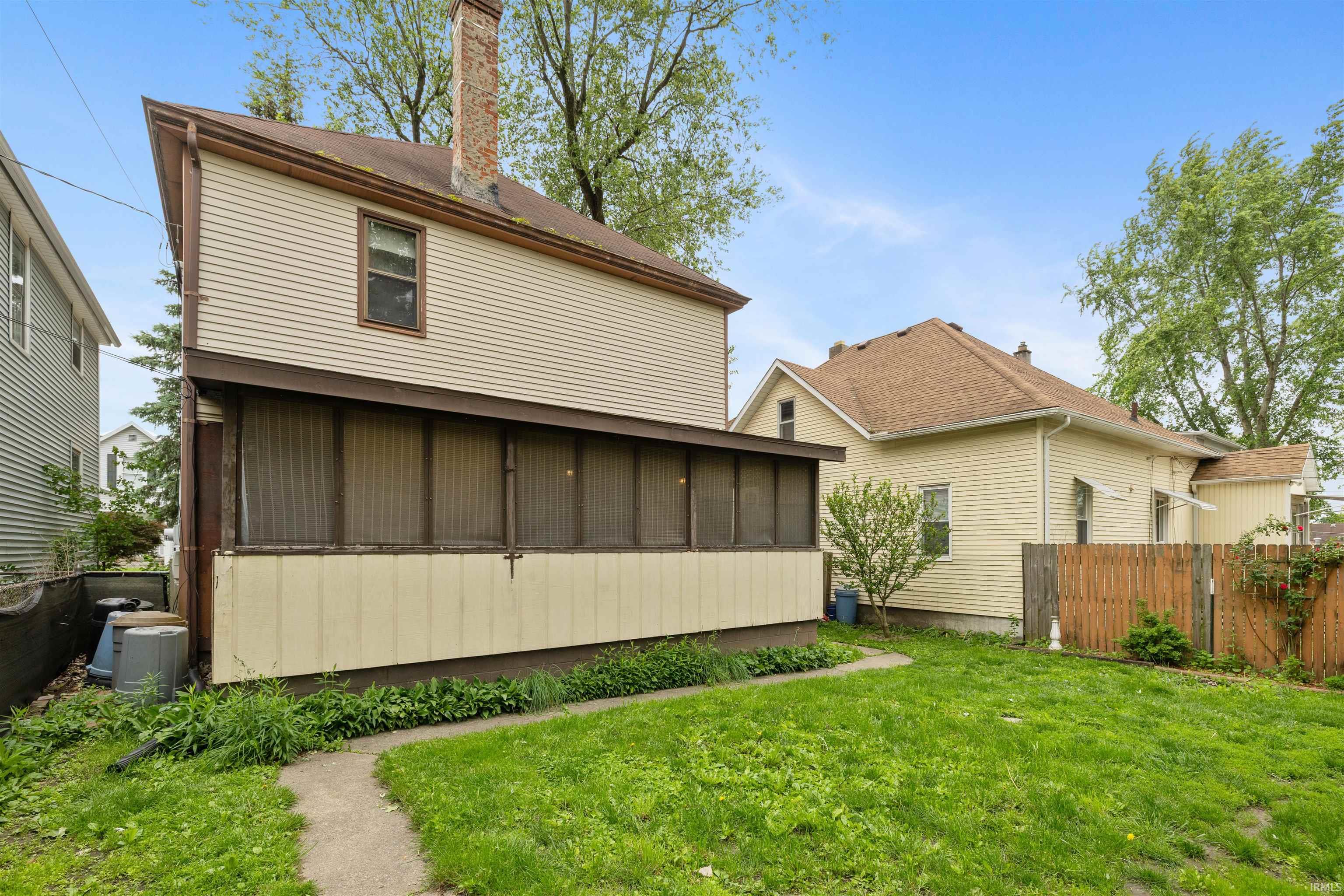 Exterior featuring a screened porch, neutral siding, and a gabled roofline