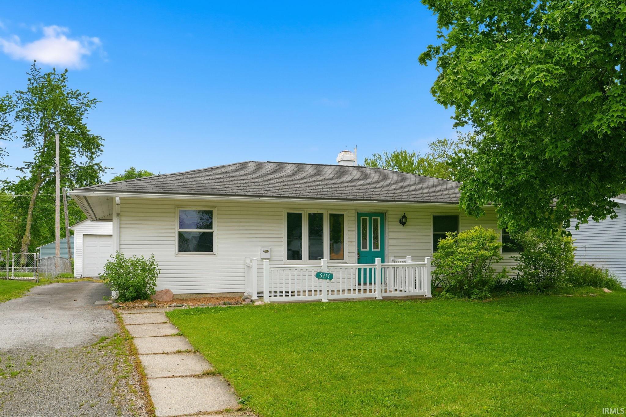 Ranch-style exterior with white siding and a dark shingle roof
