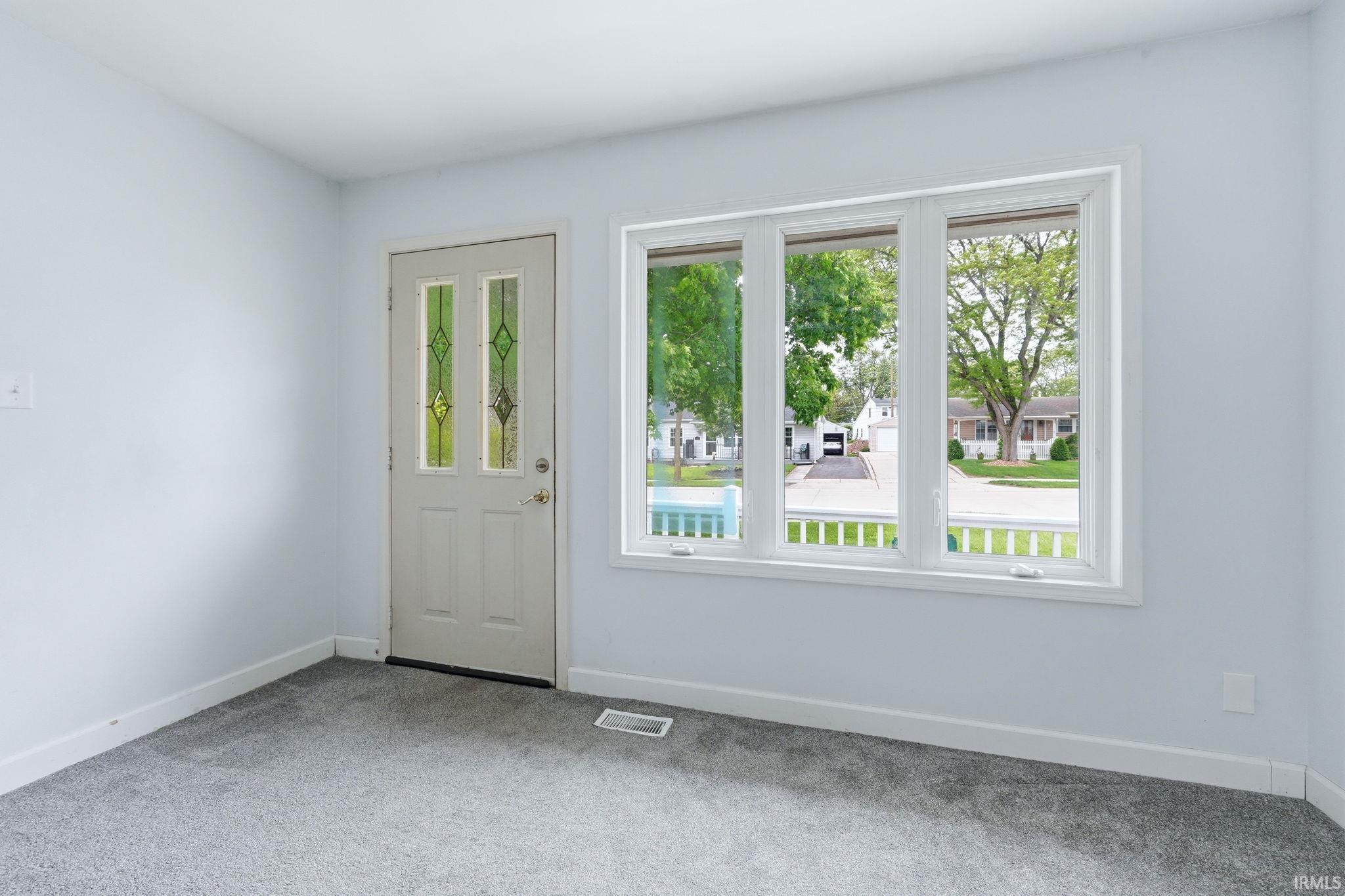 Light-filled interior featuring a three-pane window with white trim