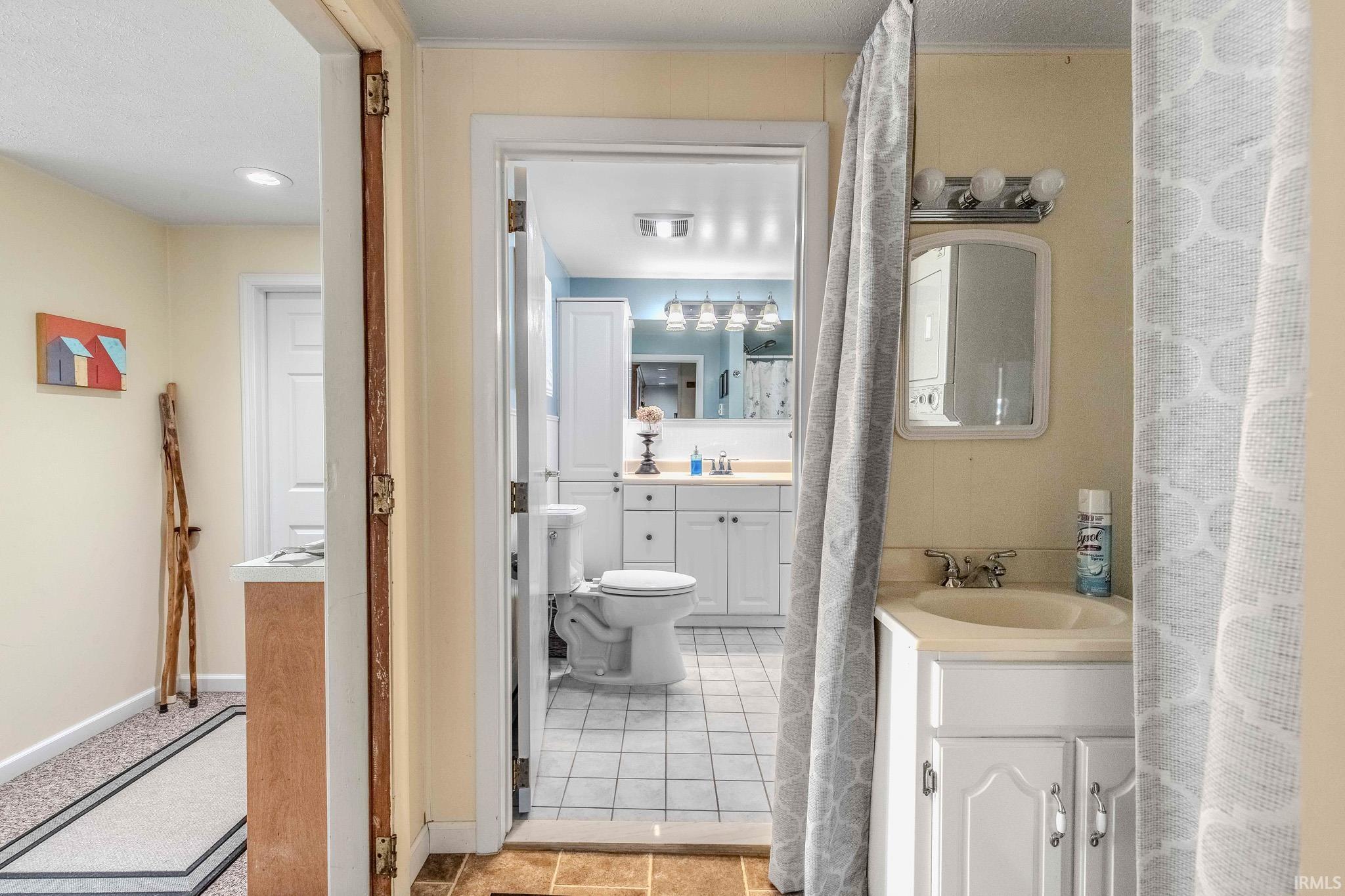 Bathroom featuring a white vanity with integrated sink, chrome faucet, and a wall-mounted mirror