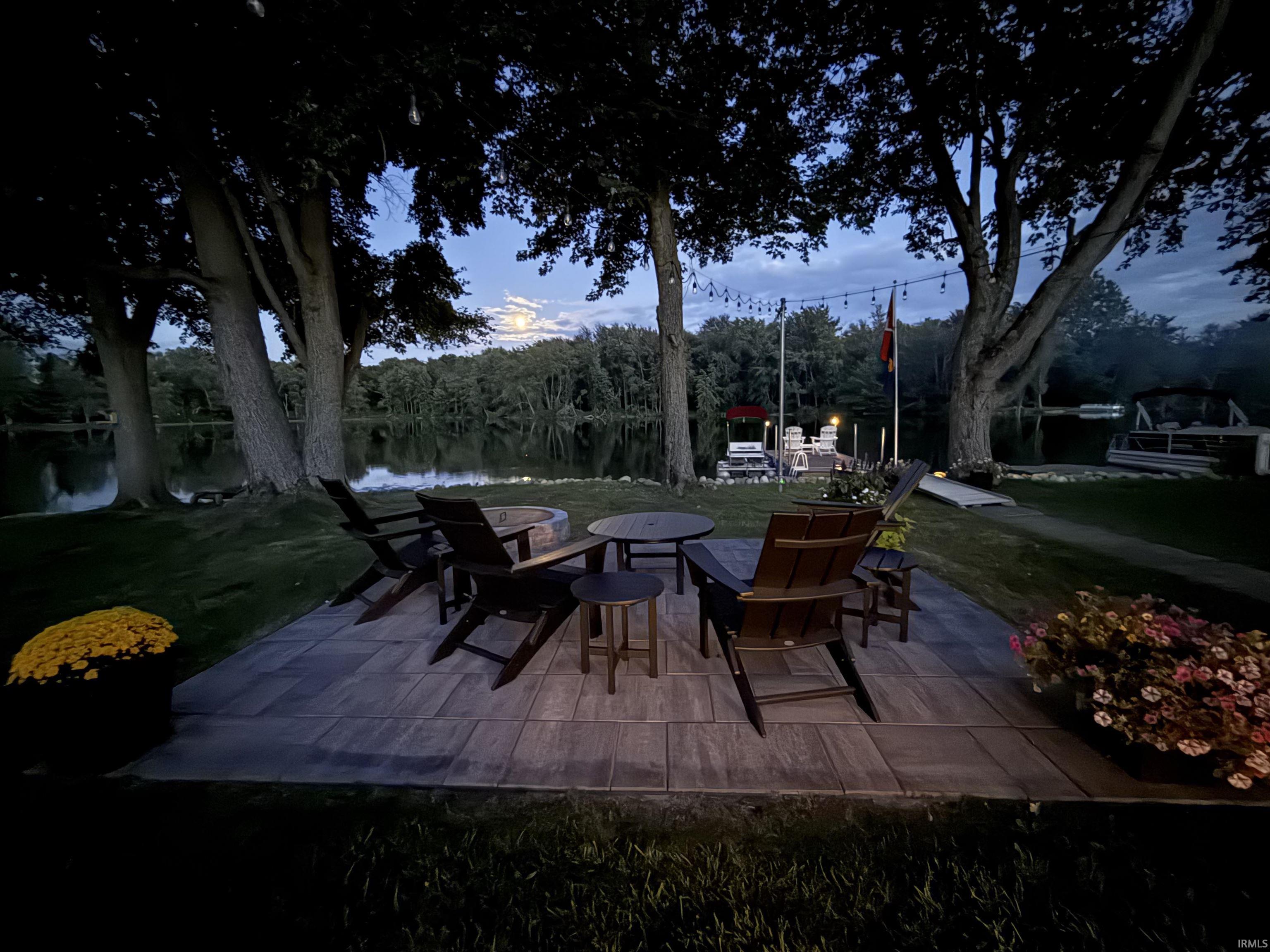 Expansive stone paver patio featuring a built-in fire pit