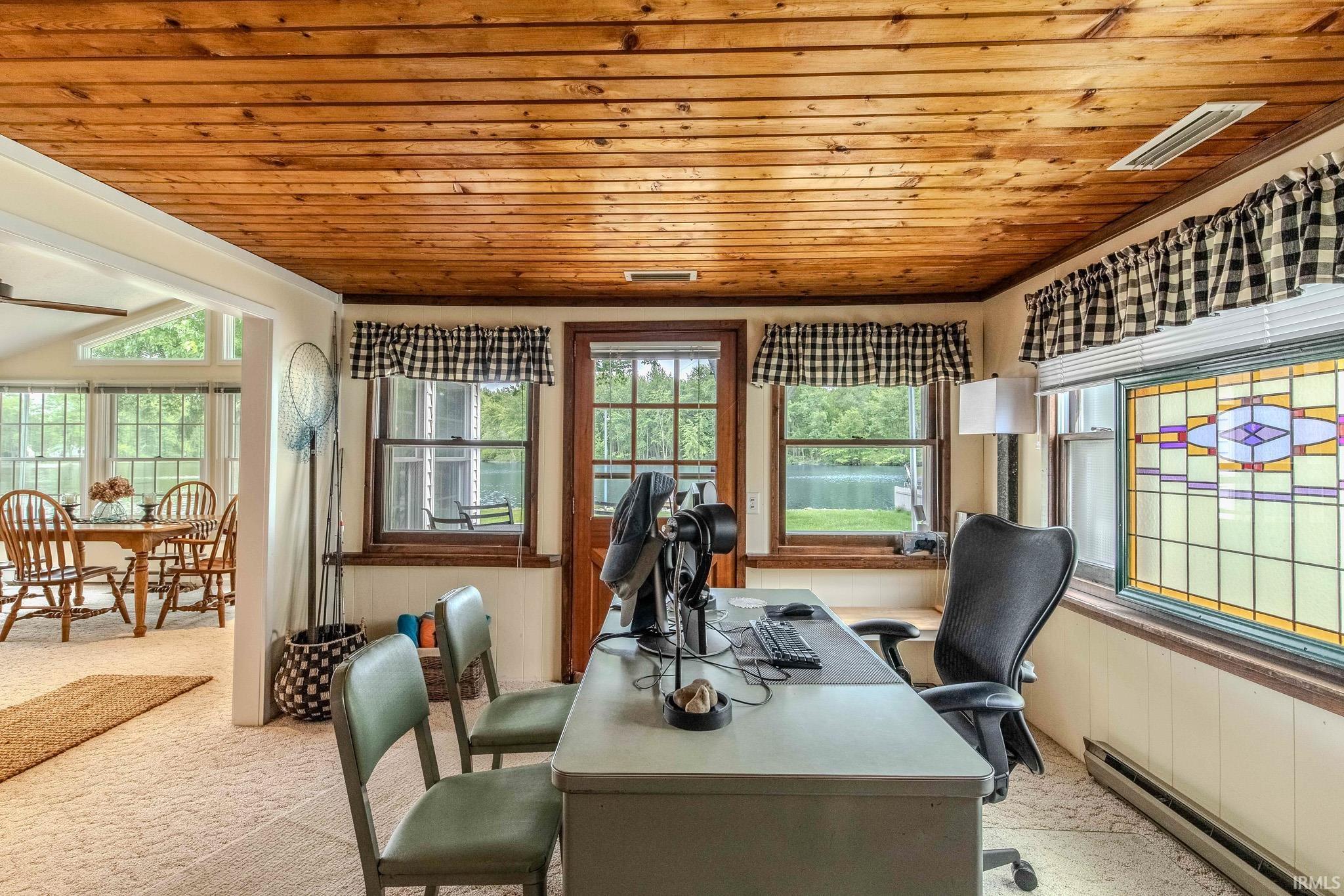 Wood-paneled ceiling room with a stained glass window