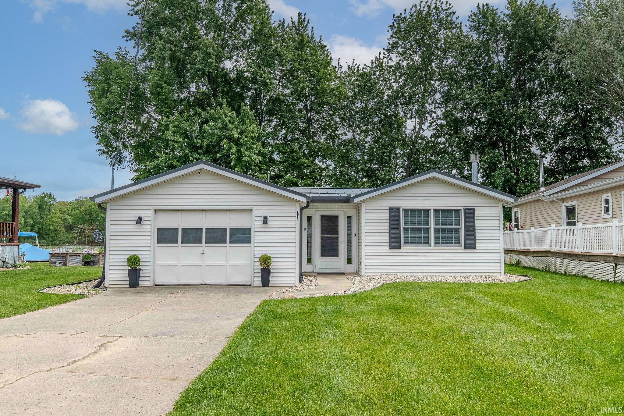 White siding exterior with a dark metal roof