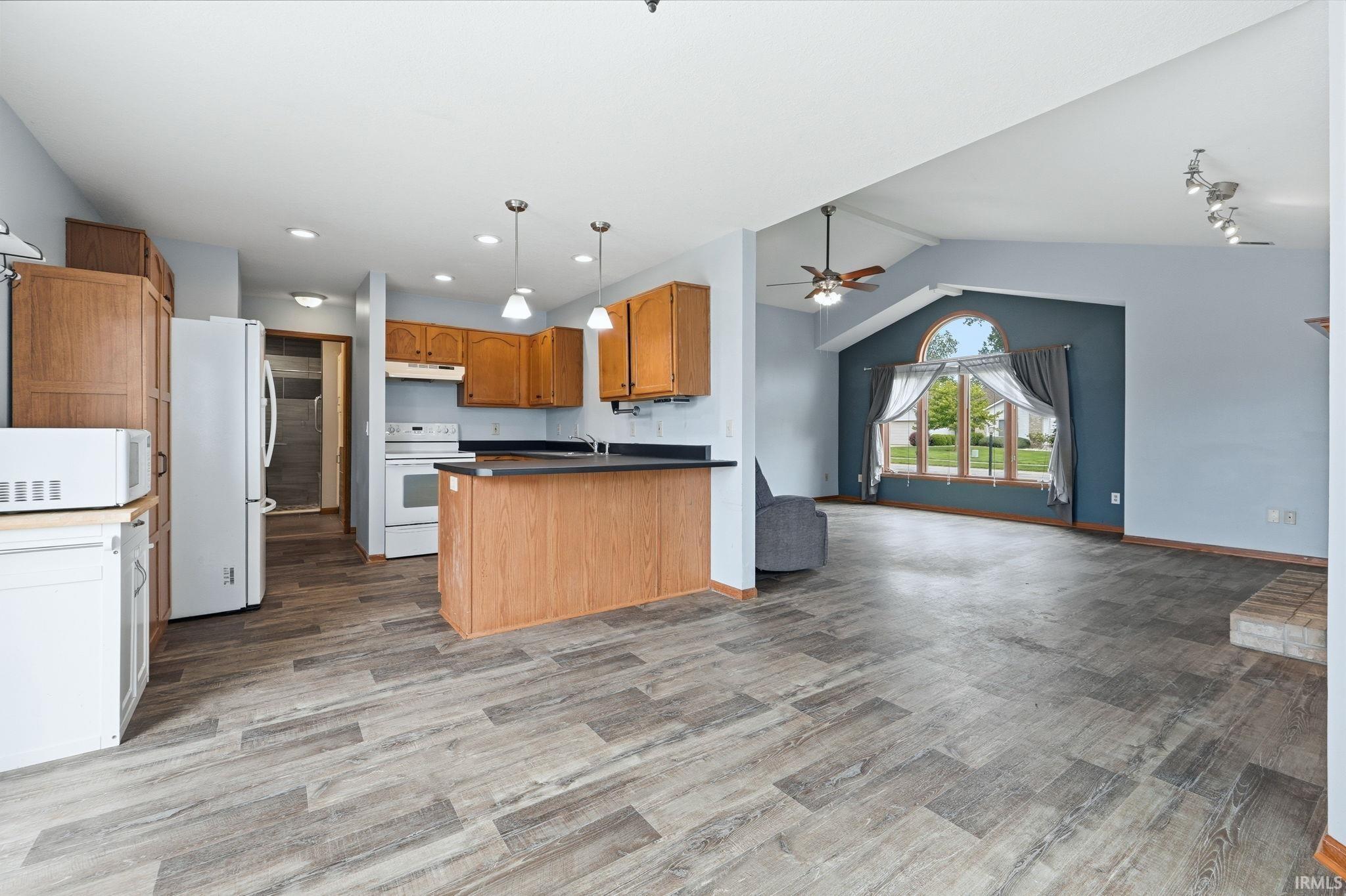 Open-concept living area with wood-finish flooring throughout