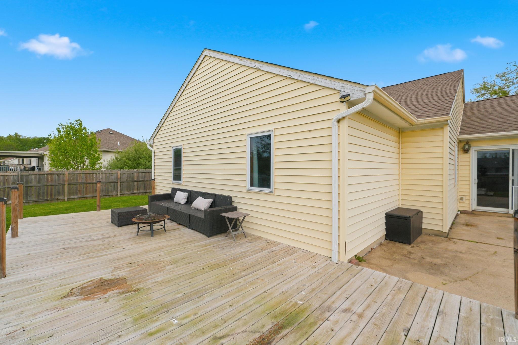 Spacious outdoor deck with wood flooring and direct access to the home via a sliding glass door