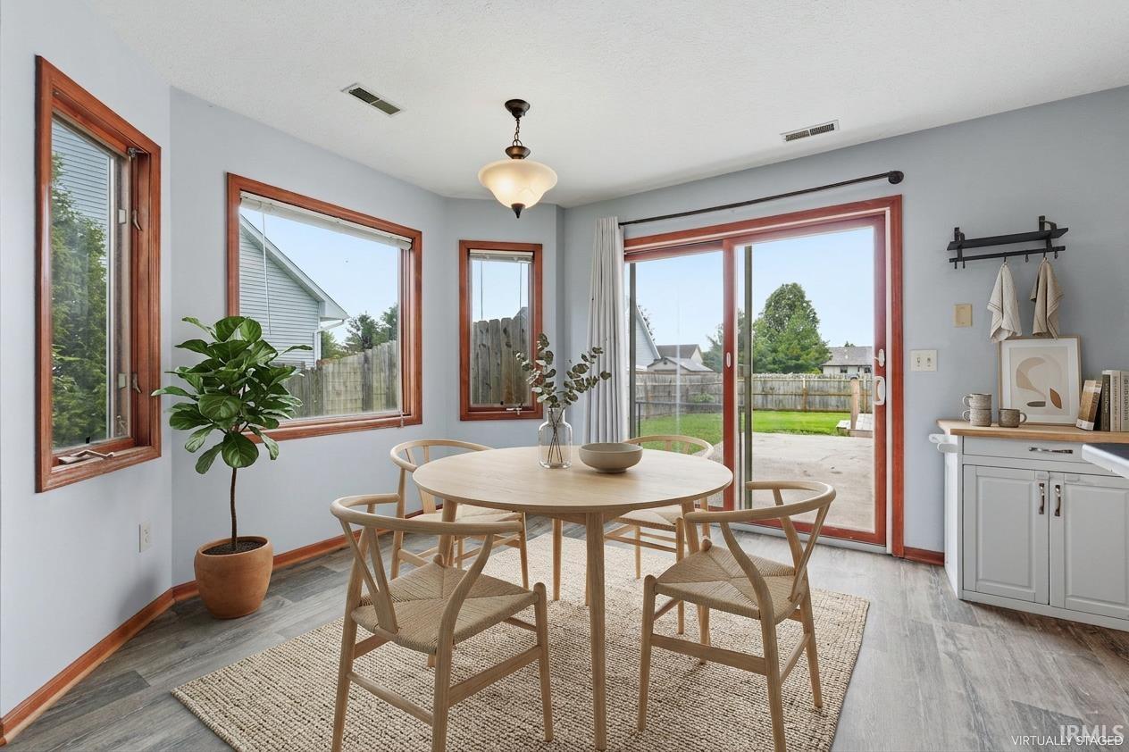 Dining area featuring wood-finish flooring and a light fixture