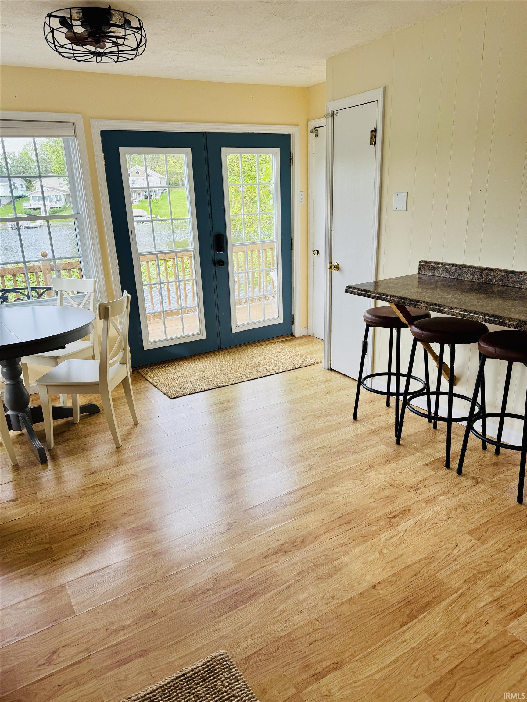 Light wood-finish flooring throughout, complemented by a breakfast bar with a speckled countertop