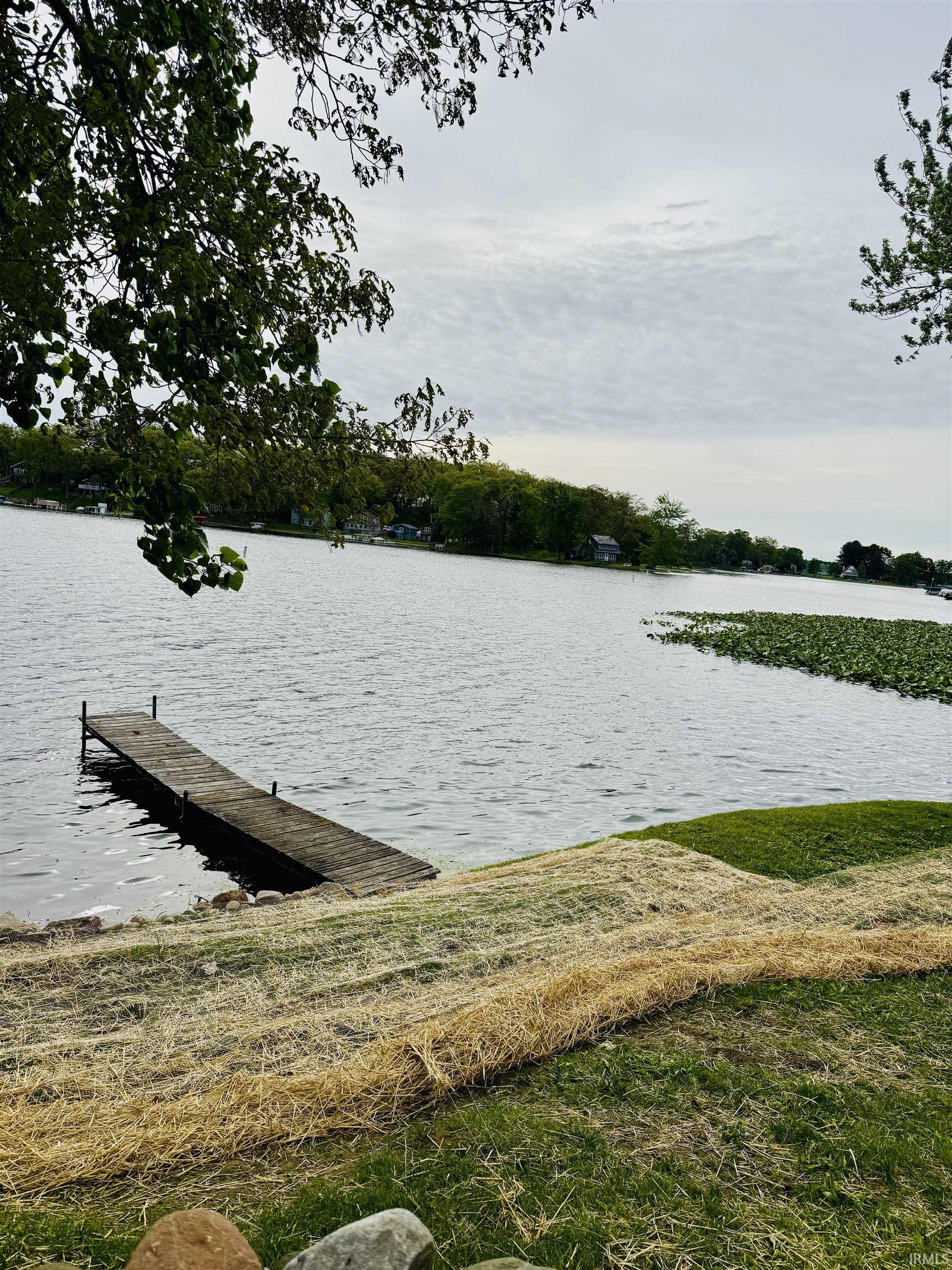 Waterfront property featuring a wooden dock extending into the lake